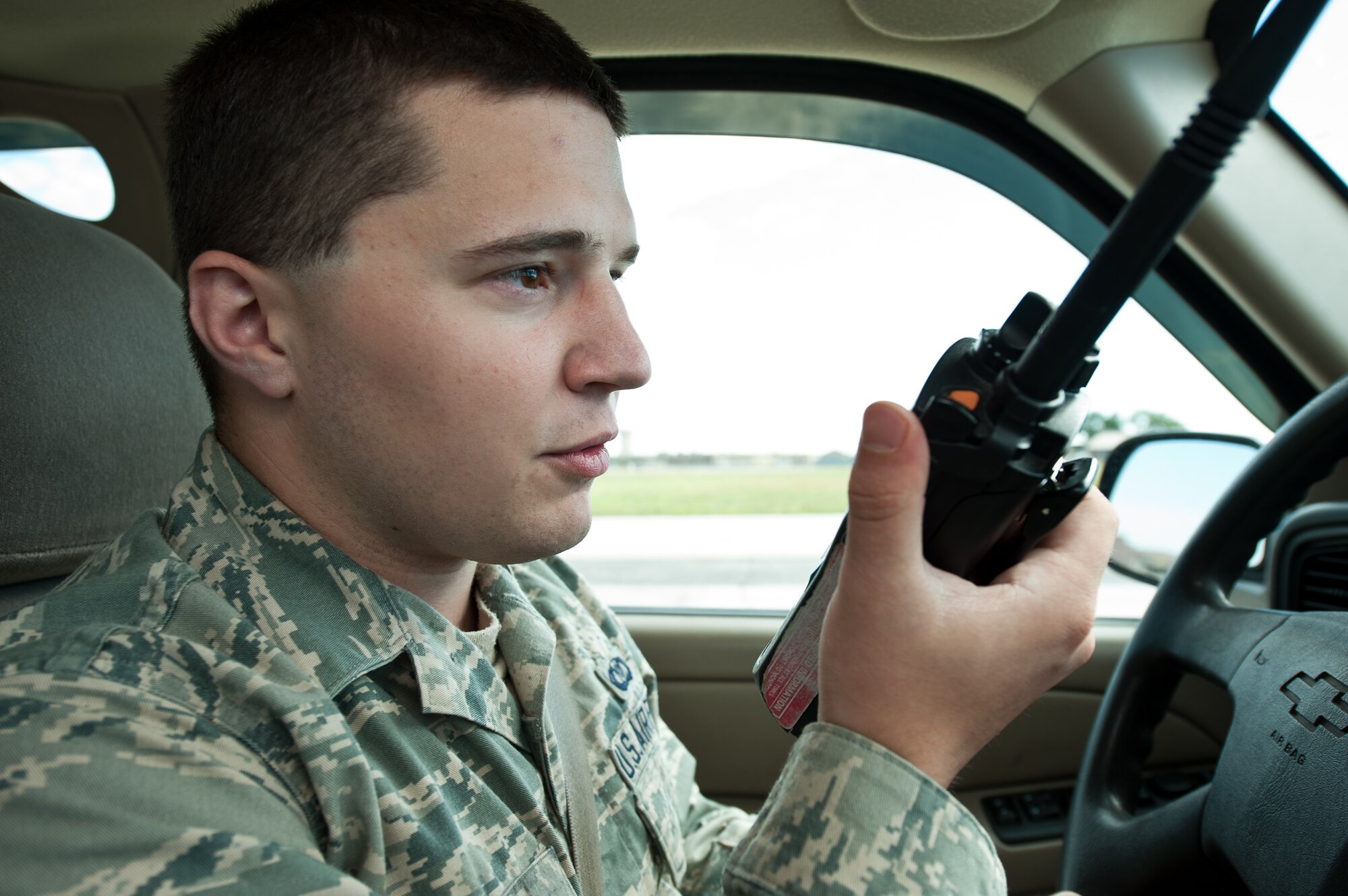 Airman 1st Class Ryan Hall, 28th Operations Support Squadron Airfield Management shift lead, requests permission from the base air traffic control tower to enter the active runway during a foreign object and debris check at Ellsworth Air Force Base, S.D., July 18, 2013. Airfield management Airmen are responsible for maintaining and managing all movements on the airfield. (U.S. Air Force photo by Airman 1st Class Alystria Maurer/Released)