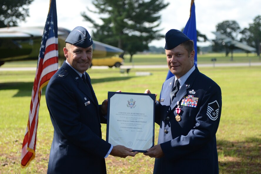 Col. Scott Arcuri (left), 20th Mission Support Group commander, presents Master Sgt. Lindley Hummel with his certificate of retirement at Shaw Air Force base, S.C., July 19, 2013. Hummel retired after 24 years of service and plans to go into law enforcement. (U.S. Air Force photo by Airman 1st Class Daniel Blackwell/Released)