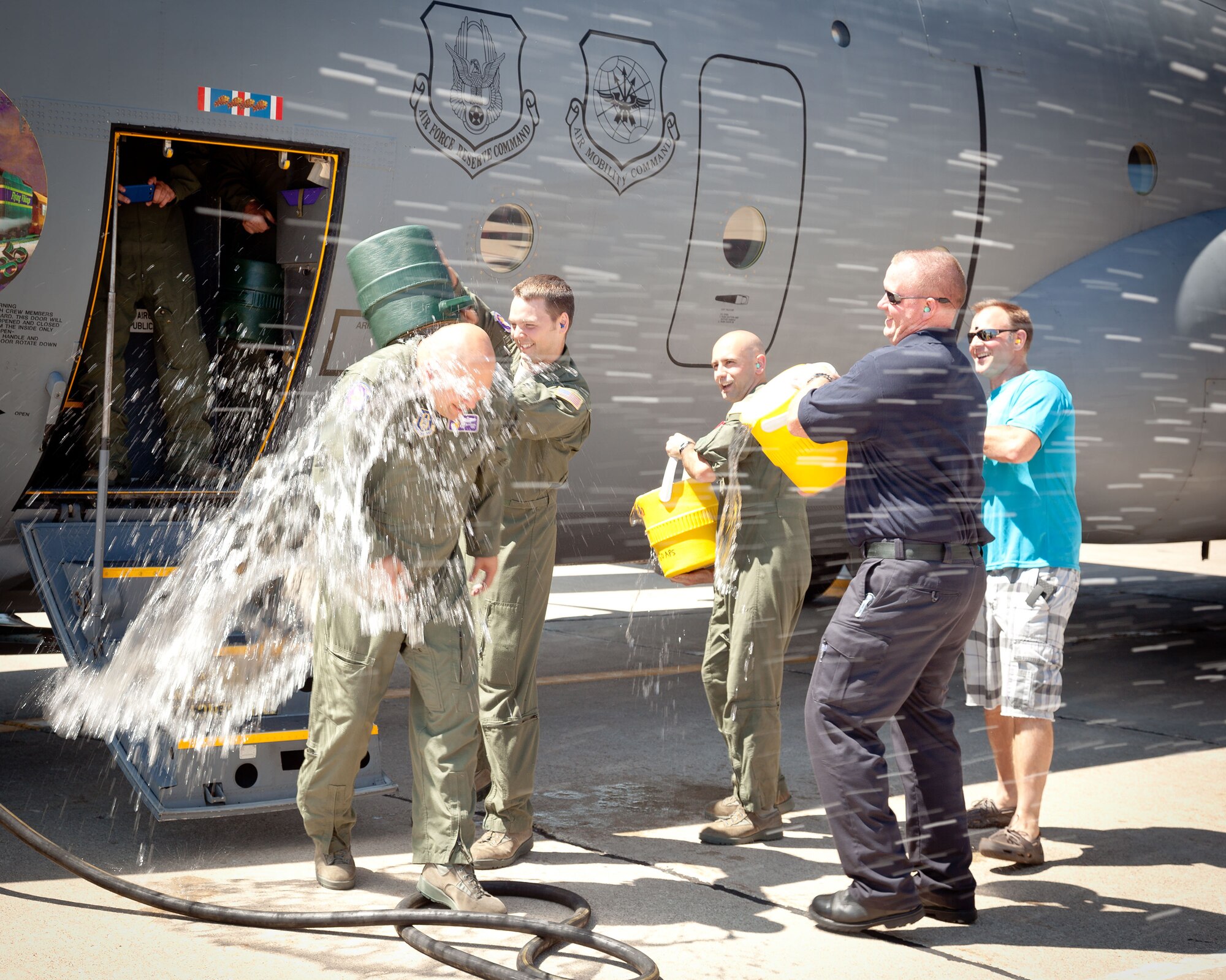 Master Sgt. Charles Brynsten is doused by co-workers, friends, and family as he disembarks from the final flight of his military career.  Sergeant Brynsten retires from the 96th Airlift Squadron at the Minneapolis-St. Paul Air Reserve Station, Minn. on July 30 after over 20 years in the Air Force.  (U.S. Air Force photo/Shannon McKay)