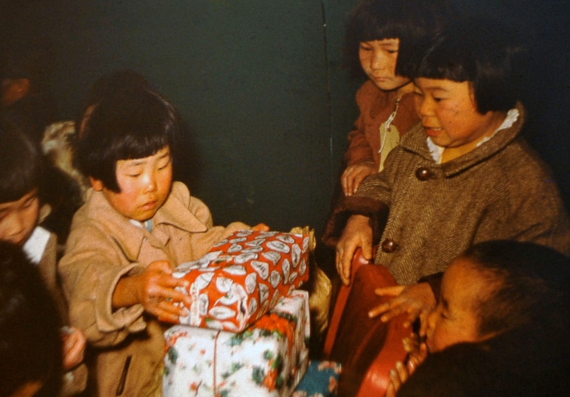 South Korean orphans open presents donated by retired U.S. Army Maj. E. Vernon Smith Jr. and his family. Smith used photography as a way to preserve memories of his experience during his rotation there from 1956-58. (Courtesy photo/Released) 