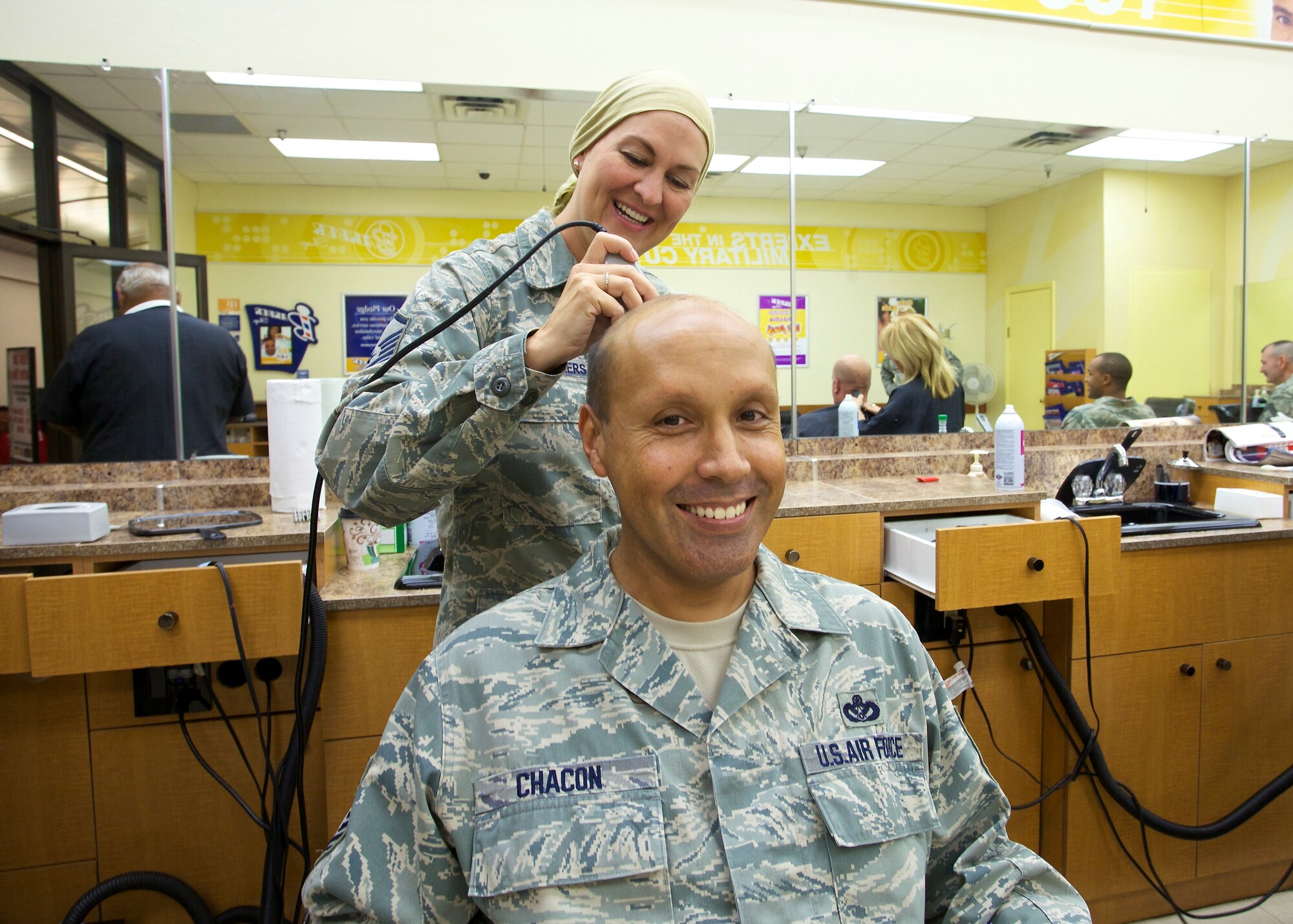 TYNDALL AIR FORCE BASE, Fla. -- Members of the Air Force Civil Engineer Center’s Force Development Division recently showed their support for Master Sgt. Marla Manyweathers who is dealing with the effects of cancer treatment by shaving their heads. She got in on the action and had some fun making sure Senior Master Sgt. Rigoberto Chacon got an especially close shave. (U.S. Air Force photo/Eddie Green)
