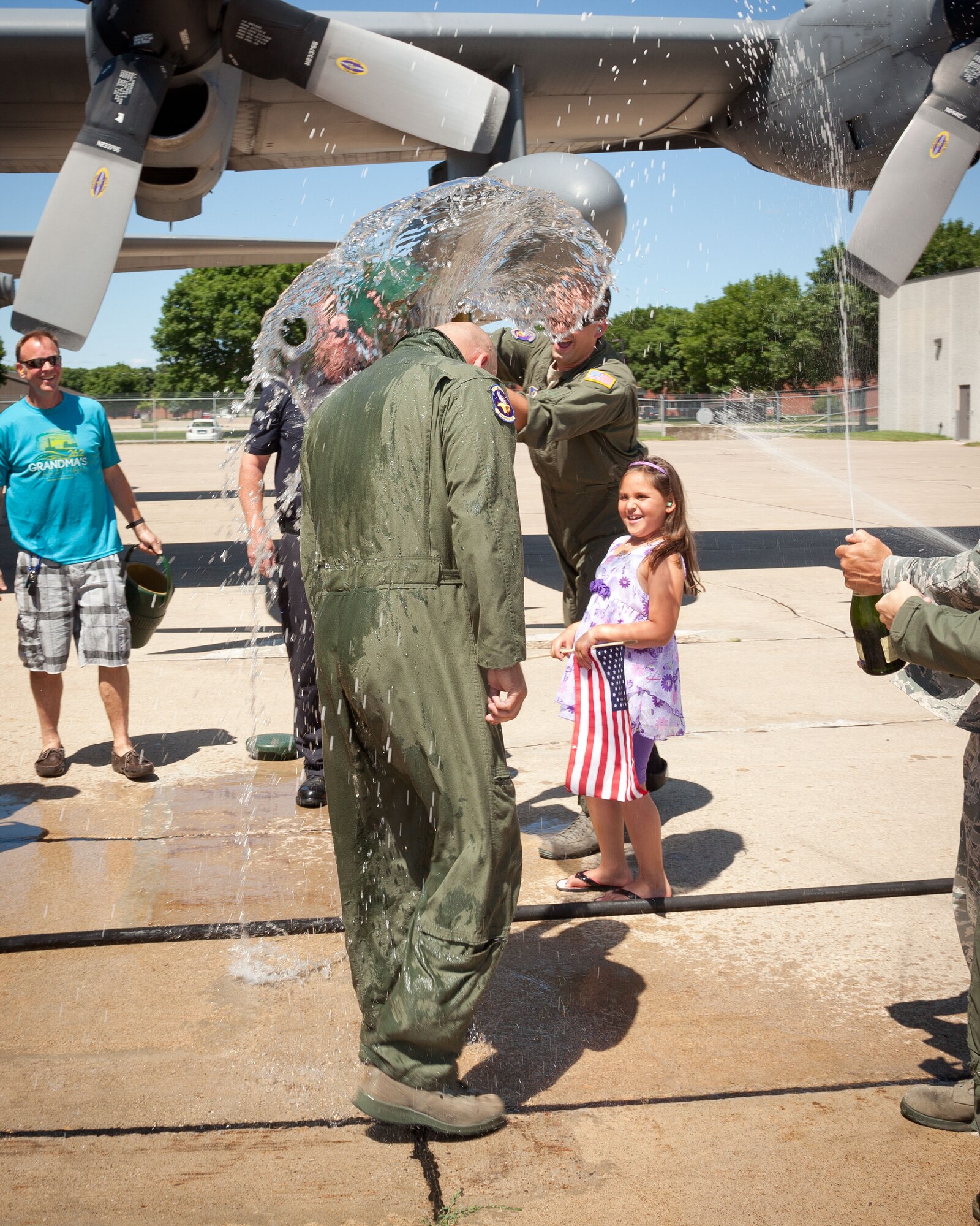 Master Sgt. Charles Brynsten is doused by co-workers, friends, and family as he disembarks from the final flight of his military career.  Sergeant Brynsten retires from the 96th Airlift Squadron at the Minneapolis-St. Paul Air Reserve Station, Minn. on July 30 after over 20 years in the Air Force.  (U.S. Air Force photo/Shannon McKay)