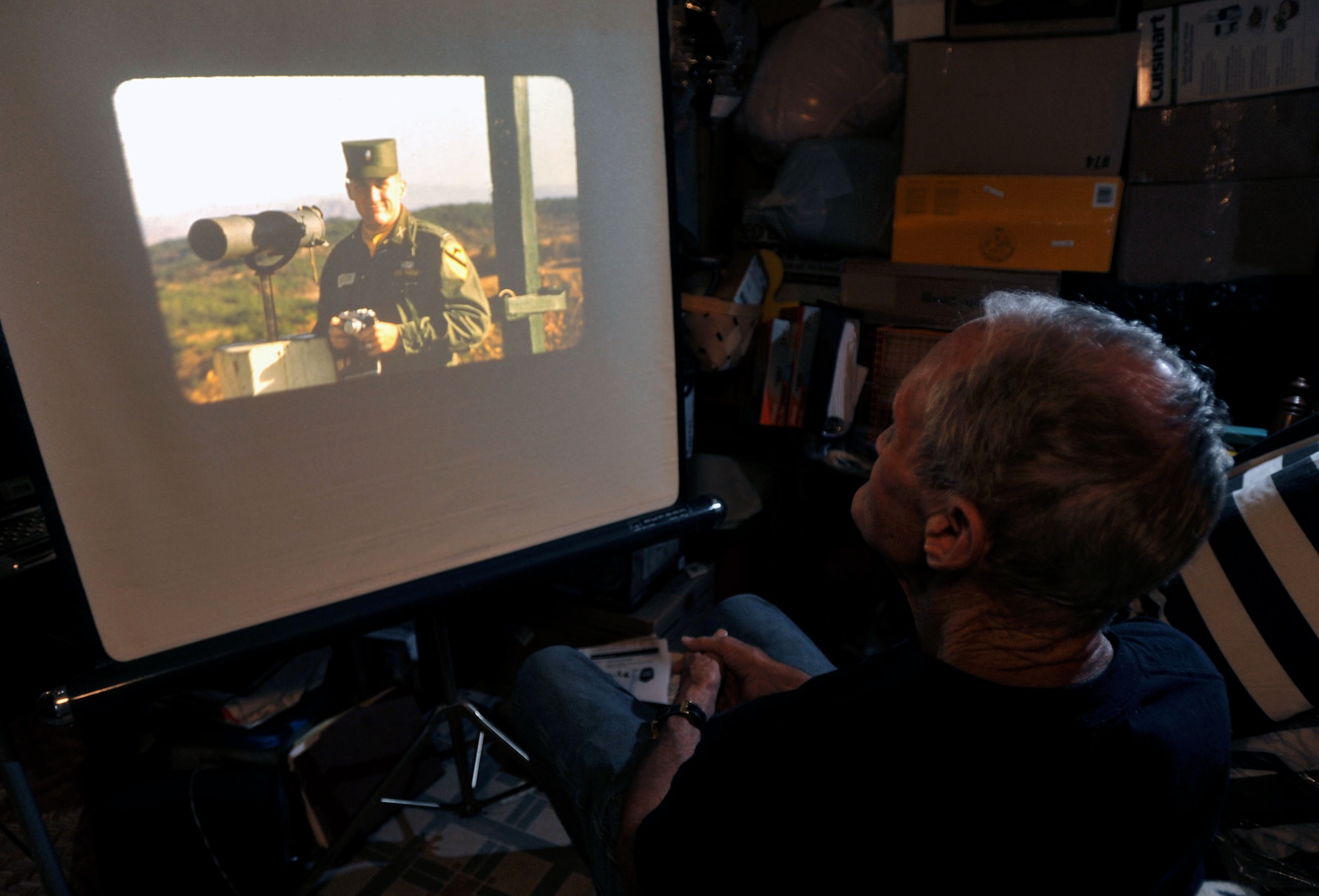 Retired U.S. Army Maj. E. Vernon Smith Jr. looks at a photo of himself as a first lieutenant while stationed in South Korea at his home in central Virginia, July 20, 2013. In support of the Korean Armistice Agreement signed July 27, 1953, Smith was assigned as the executive officer of the 24th Infantry Division Replacement Company, which later became the 1st Cavalry Division, and oversaw the logistics of coordinating replacement units. (U.S. Air Force photo by Staff Sgt. Katie Gar Ward/Released) 