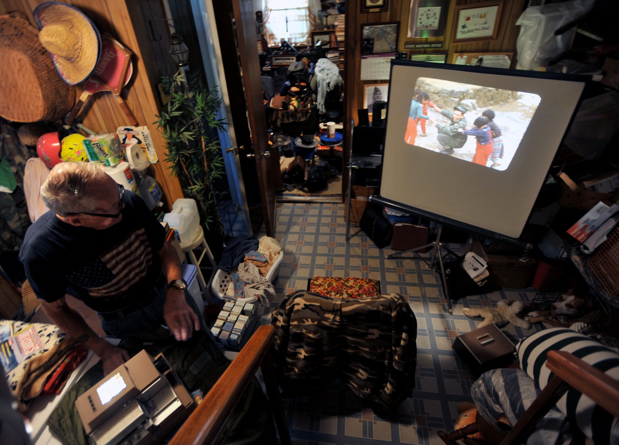 Retired U.S. Army Maj. E. Vernon Smith Jr. looks at slides from photos he took while stationed in South Korea at his home in central Virginia, July 20, 2013.  In support of the Korean Armistice Agreement signed July 27, 1953, Smith was assigned as the executive officer of the 24th Infantry Division Replacement Company, which later became the 1st Cavalry Division, and oversaw the logistics of coordinating replacement units. (U.S. Air Force photo by Staff Sgt. Katie Gar Ward/Released) 
