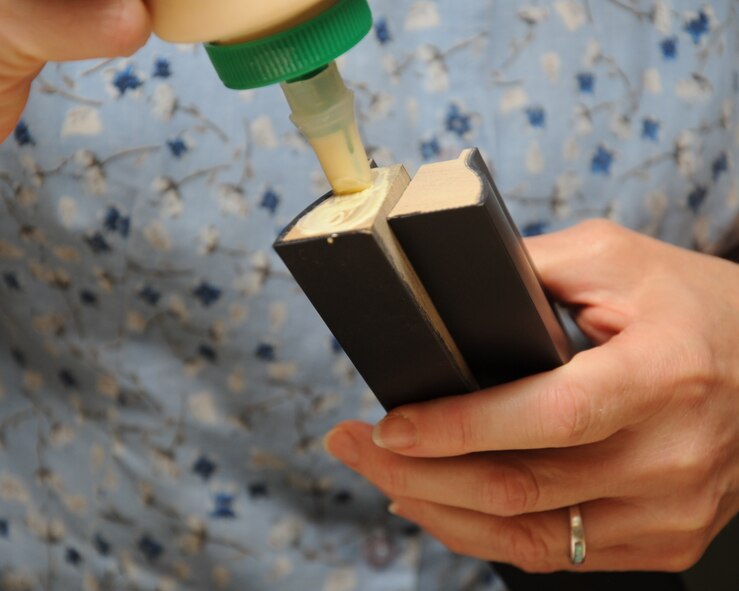 Brenda Porter, 2nd Force Support Squadron frame shop employee, applies glue to a frame on Barksdale Air Force Base, La., July 23, 2013. A frame takes about one hour to complete. (U.S. Air Force photo/Senior Airman Sean Martin)