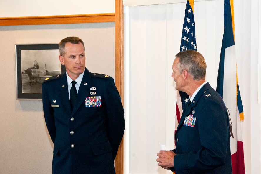 During his promotion ceremony, Lt. Col. Select Trenton Twedt (left), Maintenance Squadron Commander, 132nd Fighter Wing (132FW), Des Moines, Iowa, listens as Col. Randy Greenwood (right), 132nd Maintenance Group Commander, 132FW, give a speech on July 3, 2013.  (U.S. Air National Guard photo by Senior Airman Dustin M. Smart/Released)