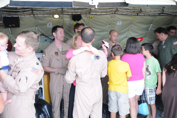 Members from the 459th Operations Group hug family members after they landed on the runway at Joint Base Andrews, Md., July 22, 2013. The members returned home from a deployment to Southwest Asia in support of Operation Enduring Freedom. (U.S. Air Force photo/ Capt. Tim Smith)