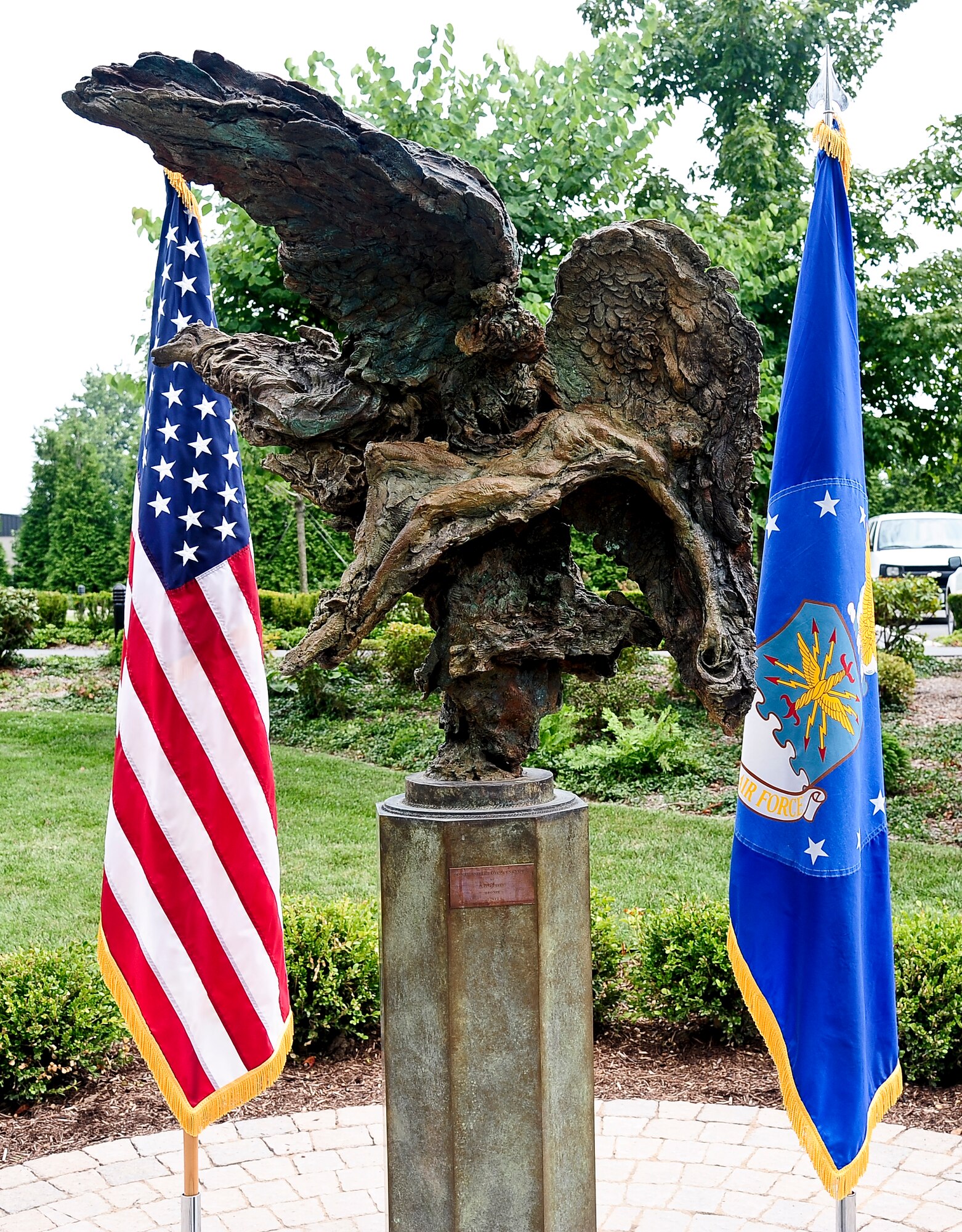 The Angel and the Dying Unknown, a bronze sculpture created by Greg Wyatt, is unveiled near the meditation garden at Dover Air Force Base, Del., July 22, 2013. The sculpture depicts a guardian angel holding and protecting a wounded soldier and serves as a quiet reflection on the sacrifices made by the nation’s fallen service members. It was donated by the Newington-Cropsey Foundation. (U.S. Air Force photo by Senior Airman Melanie Bulow-Kelly/Released)