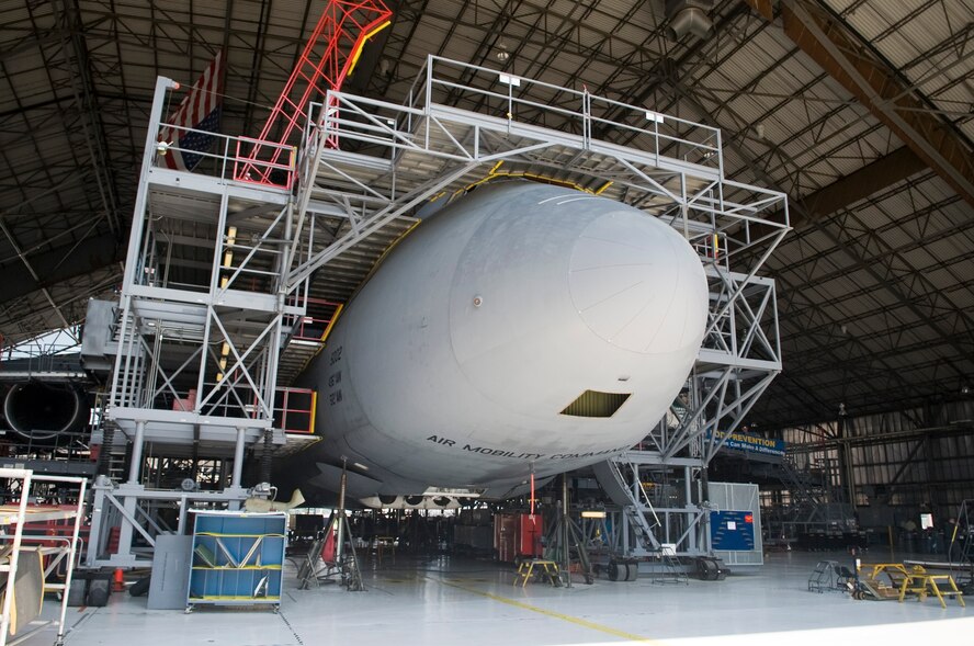 C-5M Super Galaxy rest on jacks due to front landing gear malfunction 19 July, 2013, at Dover Air Force Base, Del. Gear checks are a part of the Maintenance Steering Group three major inspections. In this case, personnel found a wire had broken causing the front landing gear to stay in the up position. (U.S. Air Force photo/Senior Airman Jared Duhon) 