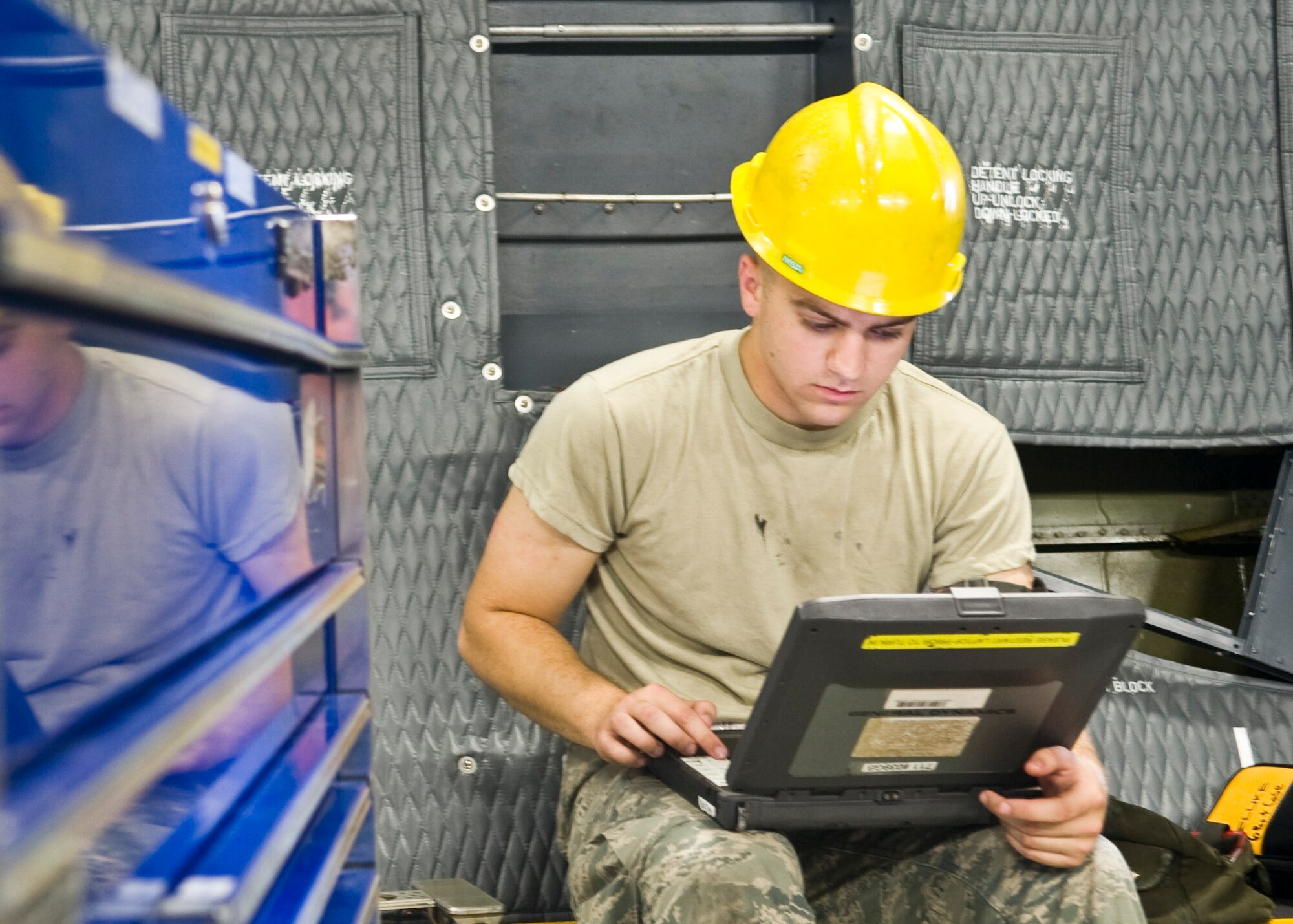 Airman 1st Class Andrew Rogers, 436th Maintenance Group electrical and environmental technician, reviews wiring schematics for the C-5M Super Galaxy landing gear July 19, 2013, at Dover Air Force Base, Del. After finding the proper wires E&E can fix the wire allowing the aero repair shop to finish checks on landing gear. (U.S. Air Force photo/Senior Airman Jared Duhon) 