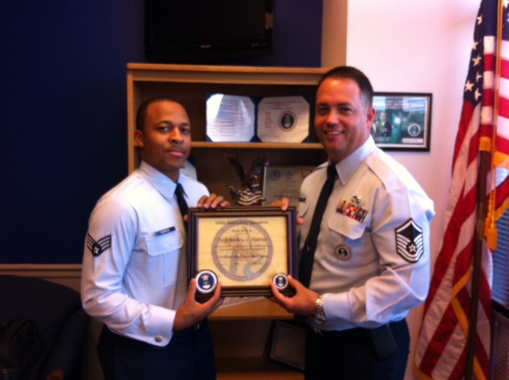 Master Sgt. Michael Whitten, 345th Recruiting Squadron H-flight chief (right), congratulates Senior Airman Rickey Harris, 345 RCS recruiter, on his certification as an enlisted accessions recruiter. (U.S. Air Force photo/Senior Master Sgt. Michael Kovach)