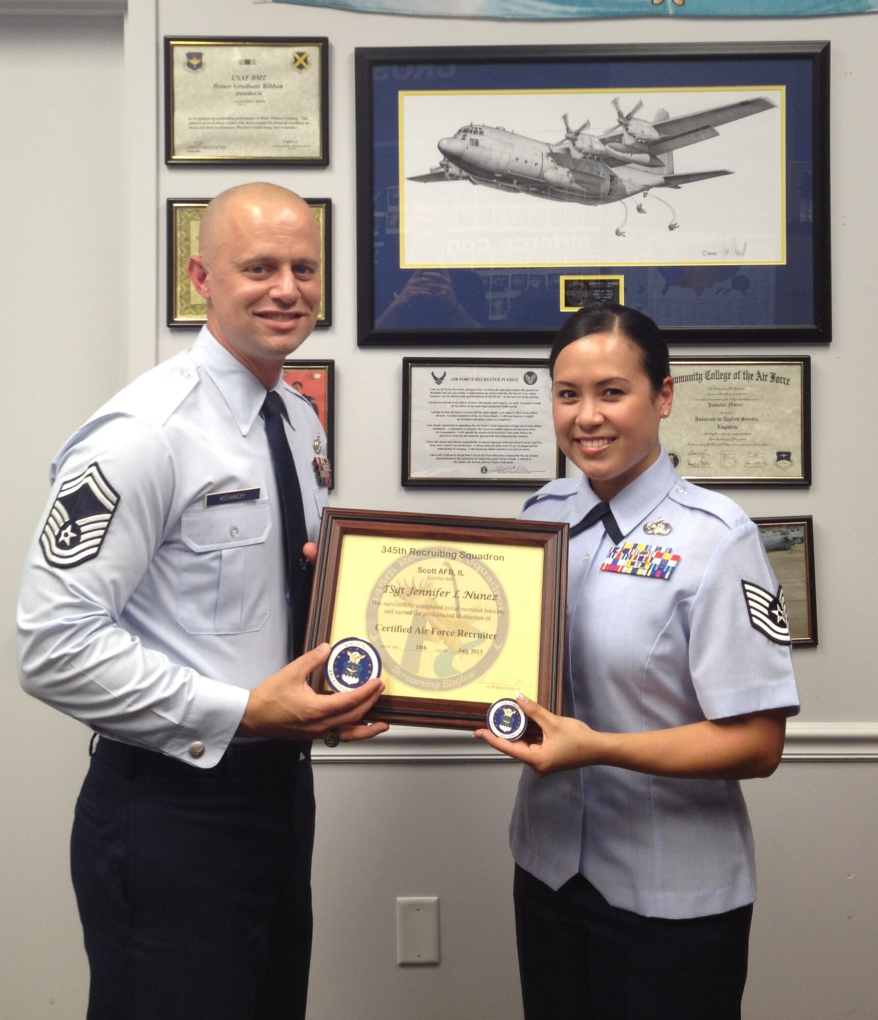 Senior Master Sgt. Michael Kovach, 345th Recruiting Squadron production superintendent (left), certifies Tech. Sgt. Jennifer Nunez, 345 RCS enlisted accessions recruiter, at the Mt. Vernon, Ill., recruiting office June 10. Nunez recently completed an Associate of Applied Science degree in human resource management from the Community College of the Air Force.  She also recently finished senior enlisted joint professional military education and scored an excellent on her Physical Training test. (U.S. Air Force photo)