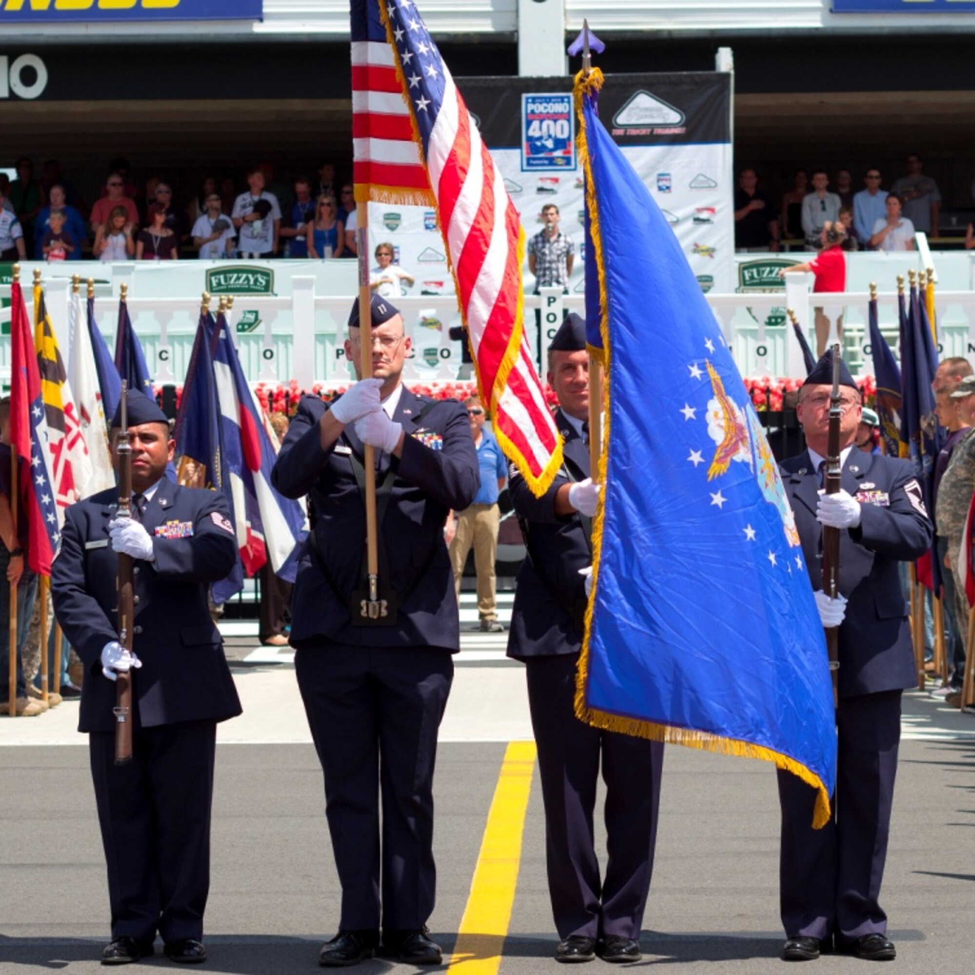 (l-r) Tech. Sgt. Frederico Flores, Capt. Nathan Goetsch, Senior Master Sgt.  Robert Shafer, and Senior Master Sgt. Glenn Perkins, 314th Recruiting Squadron Honor Guard, present the national colors before the Indy race at Long Pond, Pa., Independence Day weekend.  Eighty-five members of the Delayed Entry Program from the Air Force, Army, Navy and Marines took the oath of enlistment in front of 35,000 race goers.