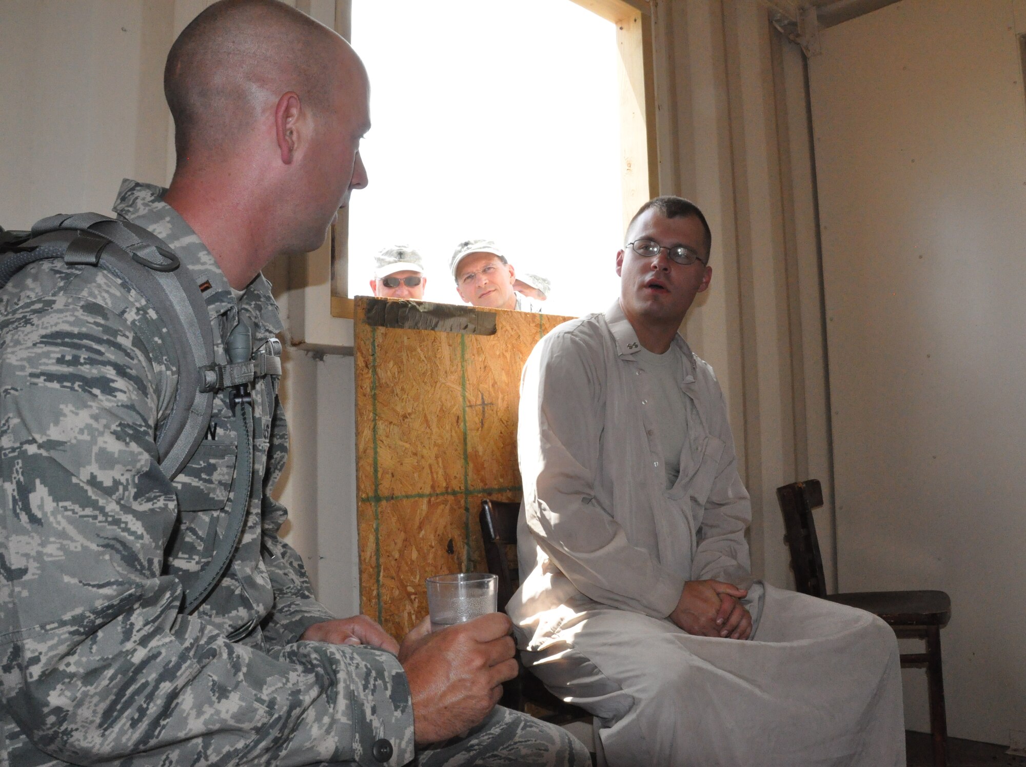 A chaplain candidate learns how to negotiate for food in a simulated deployed environment during a counterintelligence exercise Sunday, July 21 at Fort Wolters, Mineral Wells, Texas. The exercise was part of Patriot Defender, a time where candidates learn what deployed life can be like for chaplains by engaging in multiple class and hand-on training exercises. Patriot Defender is part of a five-week tour candidates embark on to see if they want to become chaplains. It is also a time when chaplain cadre can evaluate candidates and see if they would be a good fit for the program. (U.S. Air Force photo by Senior Airman Melissa Harvey)