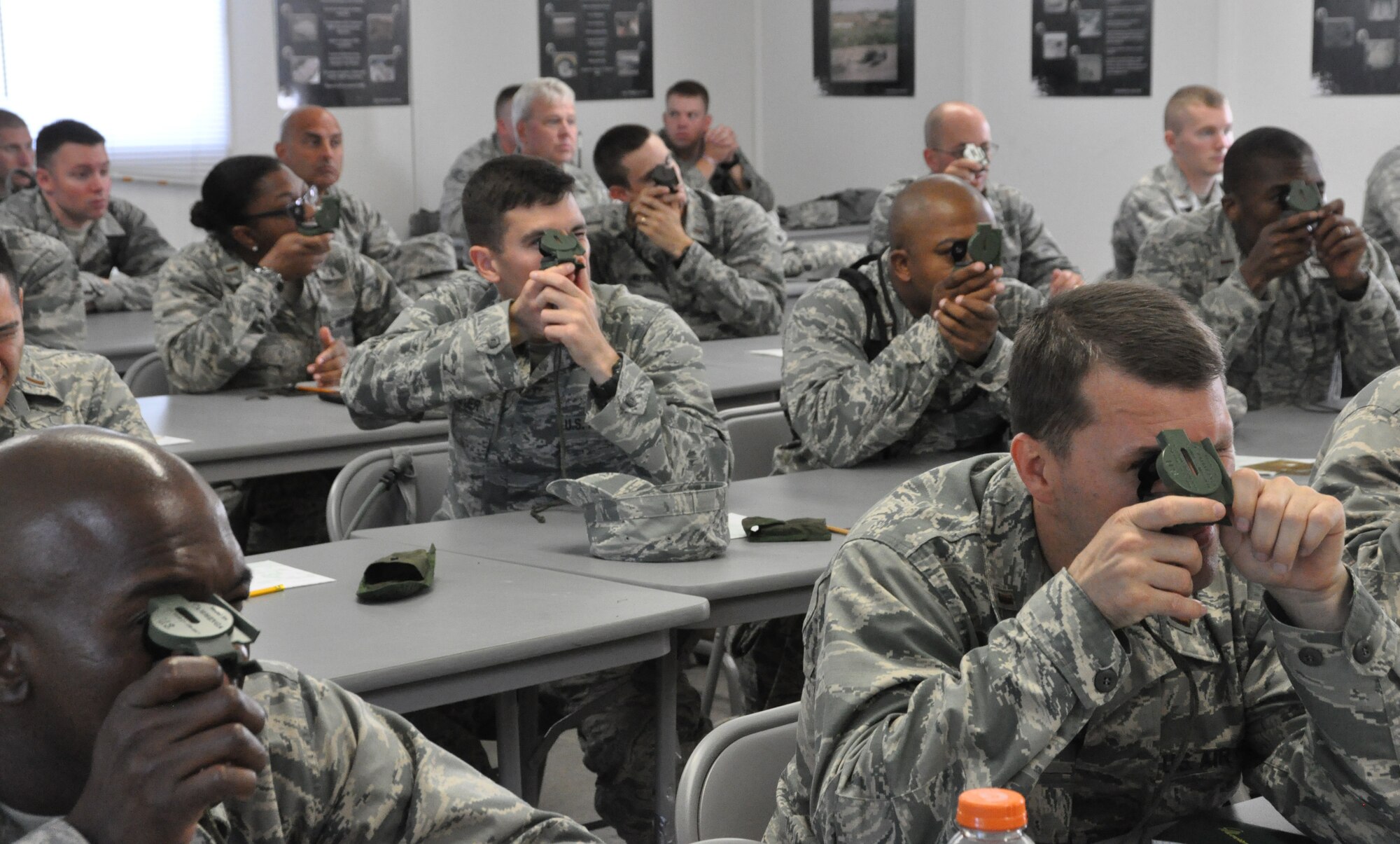 Chaplain candidates learn how to use a compass during the land navigation class portion of Patriot Defender, Saturday, July 20 at Fort Wolters, Mineral Wells, Texas. After the class, candidates embarked on a four-hour land navigation exercise. During their time at Fort Wolters, candidates learned what deployed life can be like for chaplains by engaging in multiple class and hand-on training exercises. Patriot Defender is part of a five-week tour candidates embark on to see if they want to become chaplains. It is also a time when chaplain cadre can evaluate candidates and see if they would be a good fit for the program. (U.S. Air Force photo by Senior Airman Melissa Harvey)