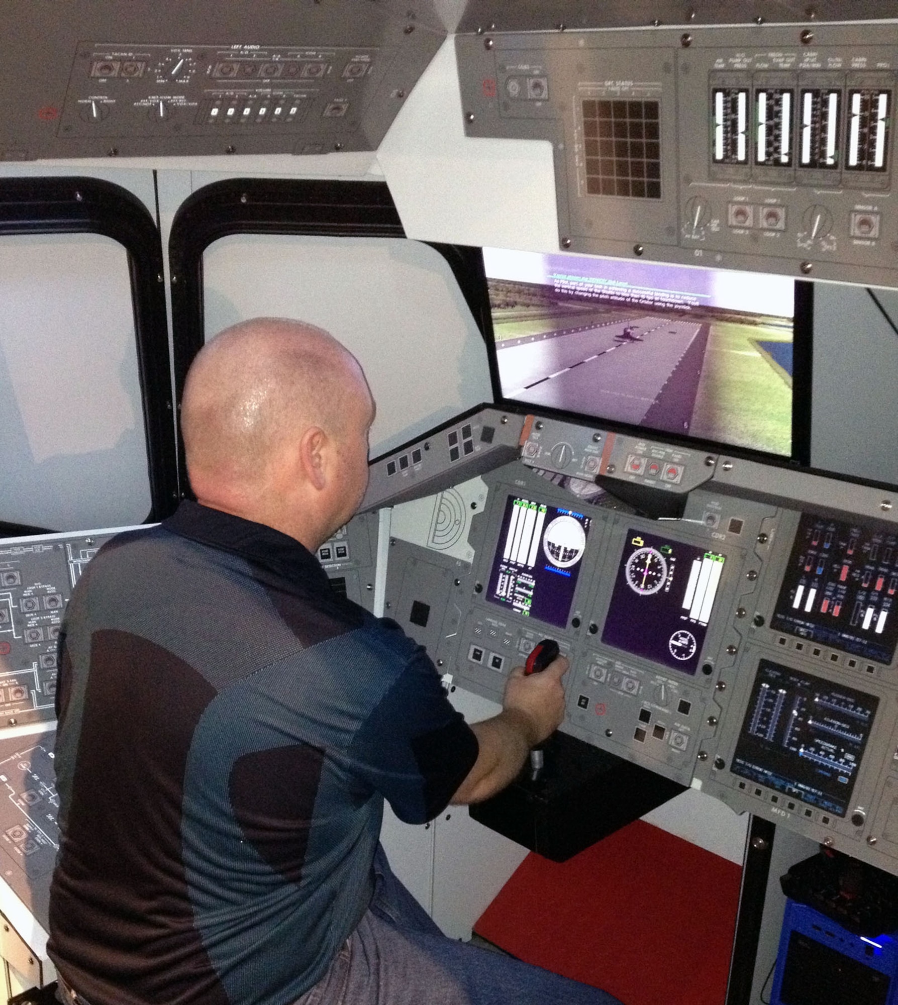 DAYTON, Ohio -- National Museum of the U.S. Air Force visitors can now test their skill at landing a space shuttle orbiter with the addition of two new interactive space shuttle landing simulators. The simulators are free of charge and allow visitors to “fly” the shuttle to a safe landing using a joystick and video screens, and receive feedback on how well they piloted the shuttle.  (U.S. Air Force Photo)
