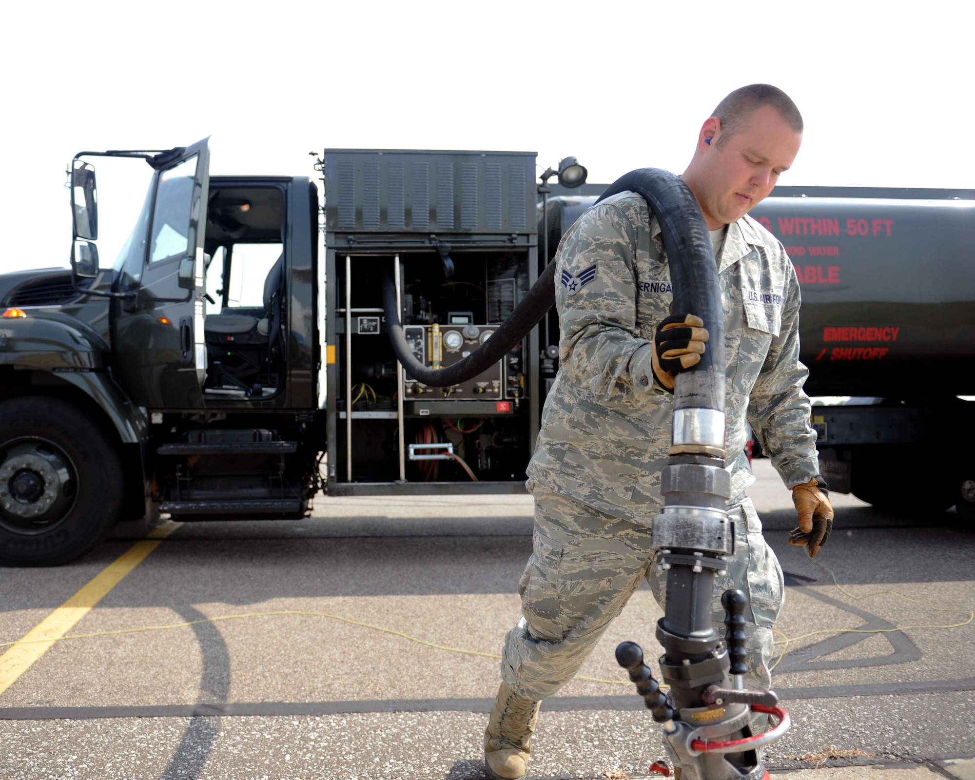 Senior Airman Casey Jernigan, 100th Logistics Readiness Squadron Fuels Distribution operator from Pontotoc, Miss., removes the hose of an R-11 refueling truck July 22, 2013, at RAF Mildenhall, England. Jernigan worked with another Airman who grounded the truck through cables attached to the underside of the vehicle. During refueling, both the truck and the aircraft are grounded to prevent sparks; which, could ignite the fuel. (U.S. Air Force photo by Airman 1st Class Preston Webb/Released)