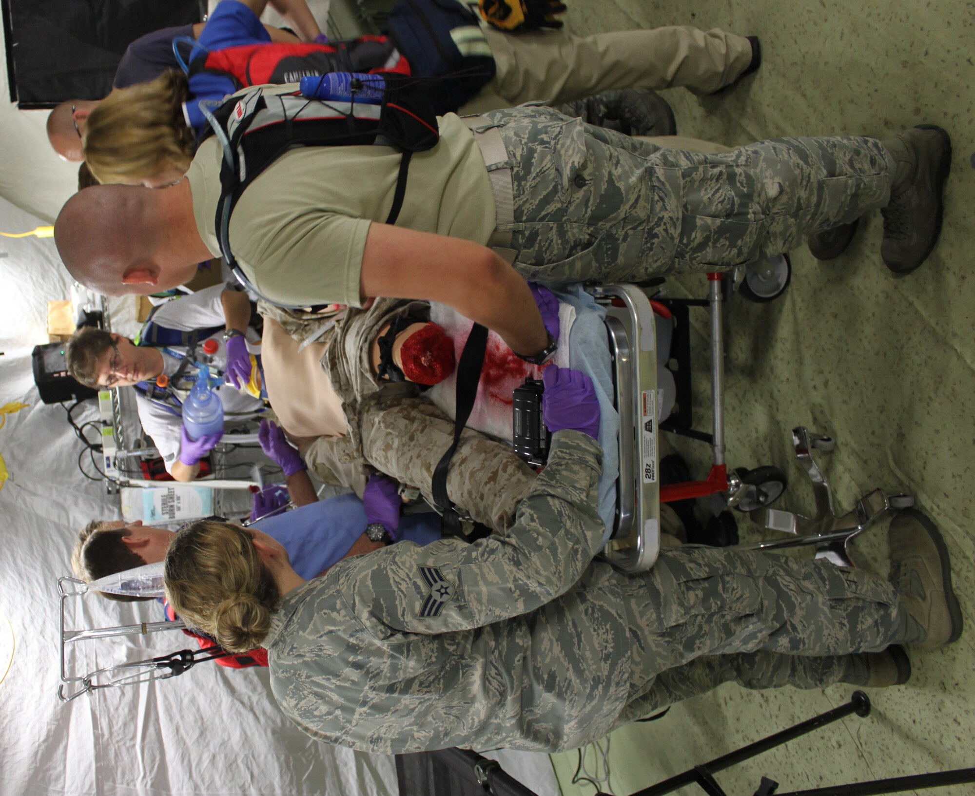 Minnesota Air National Guard 133rd Medical Group and Rhode Island Air National Guard 143rd Medical Group members execute patient care on a high fidelity mannequin, allowing medical student to use all EMEDS equipment to enhance training during exercise Patriot 2013 in Volk Field, Wis. Patriot 2013 was a joint-service and multi-state agency exercise conducted from July 13 to 20 involving more than 2,000 National Guard personnel from 26 states integrated with local and state emergency response agencies including members of the Detachment 1, 823 RED HORSE, Silver Flag Exercise Training Site.( Courtesy photo by Capt. Brett Mazey)
