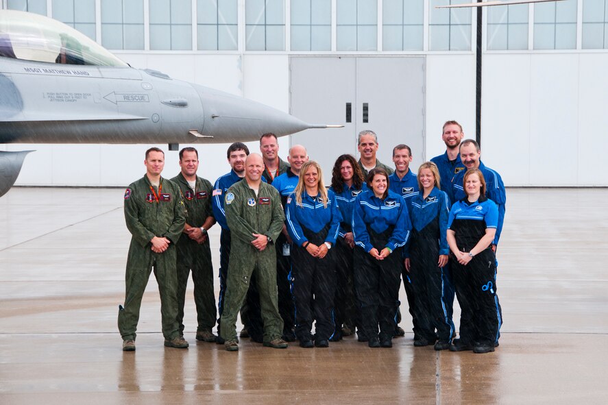 Before the rain gets too heavy, pilots from the 132nd Fighter Wing (132FW), Des Moines, Iowa, pose for a quick photo with the men and women of UnityPoint Health Life Flight and EMS technicians on July 19, 2013.  (U.S. Air National Guard photo by Senior Airman Dustin M. Smart/Released)