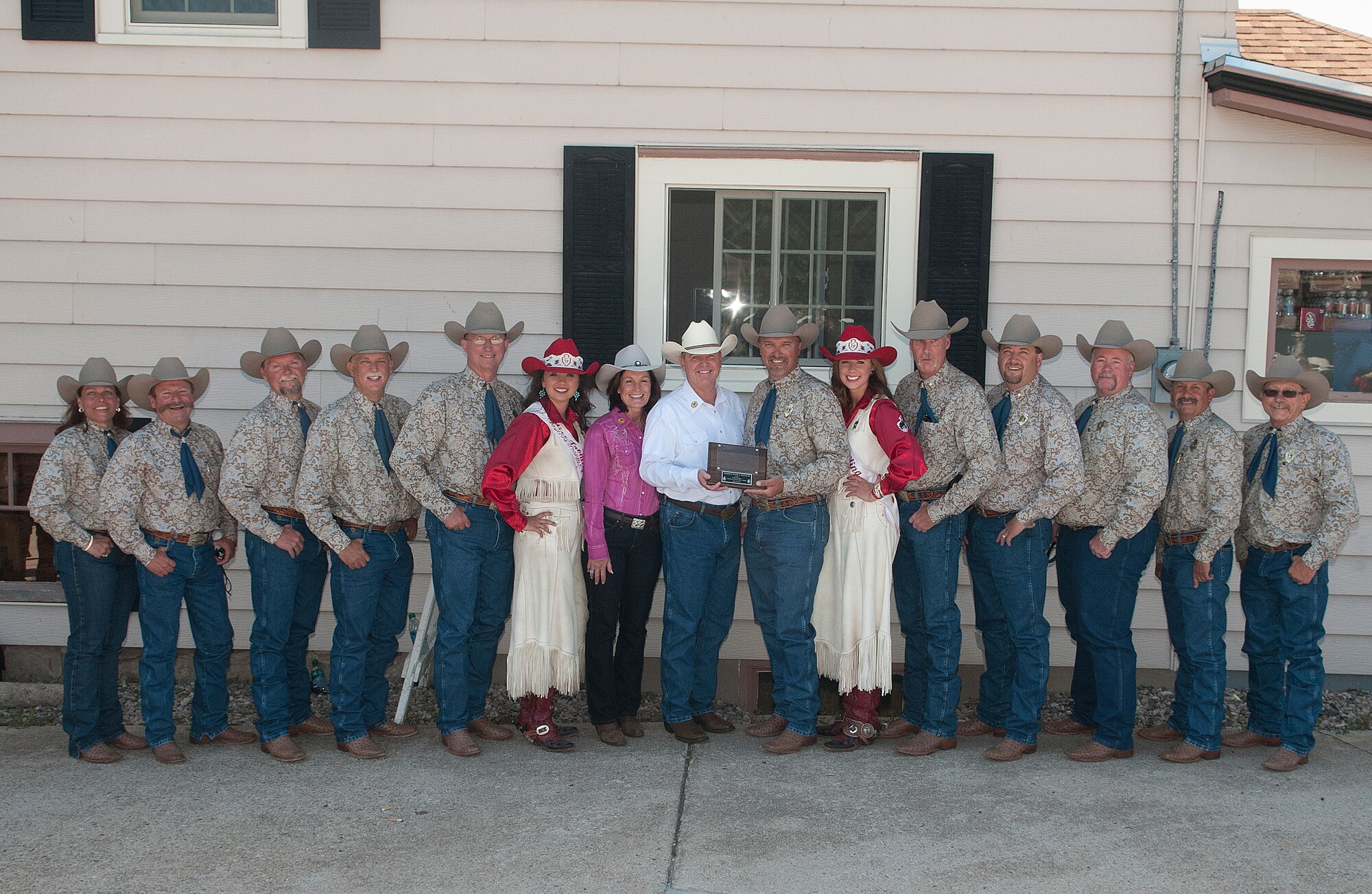 Air Force Chief of Staff Gen. Mark A. Welsh III and his wife, Betty, pose for a photograph with the 2013 Cheyenne Frontier Days committee members and Chloe Pfoor, Miss Frontier; and Kaci Malmborg, her Lady-in-Waiting; before the start of the 117th annual CFD parade July 20, 2013. Welsh, who served as grand marshal for the opening parade, visited the region to participate in CFD events, but also to thank Airmen and the community for the continued service and support. (U.S. Air Force photo by R.J. Oriez)