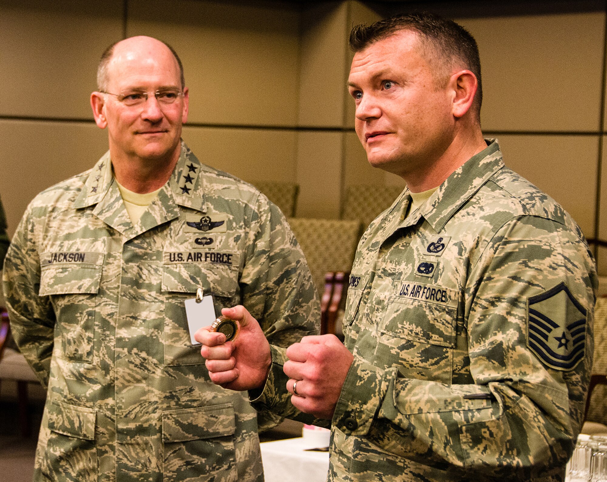 Master Sgt. Shawn Jones, Air Force Reserve Command recruiting service public affairs, thanks senior leaders after learning he is one of the 12 Outstanding Airmen of the Year. Lt. Gen. James F. Jackson (left), AFRC commander, personally congratulated Jones on July 22, 2013, at Robins Air Force Base, Ga. (U.S. Air Force photo by Staff. Sgt. Alexy Saltekoff)