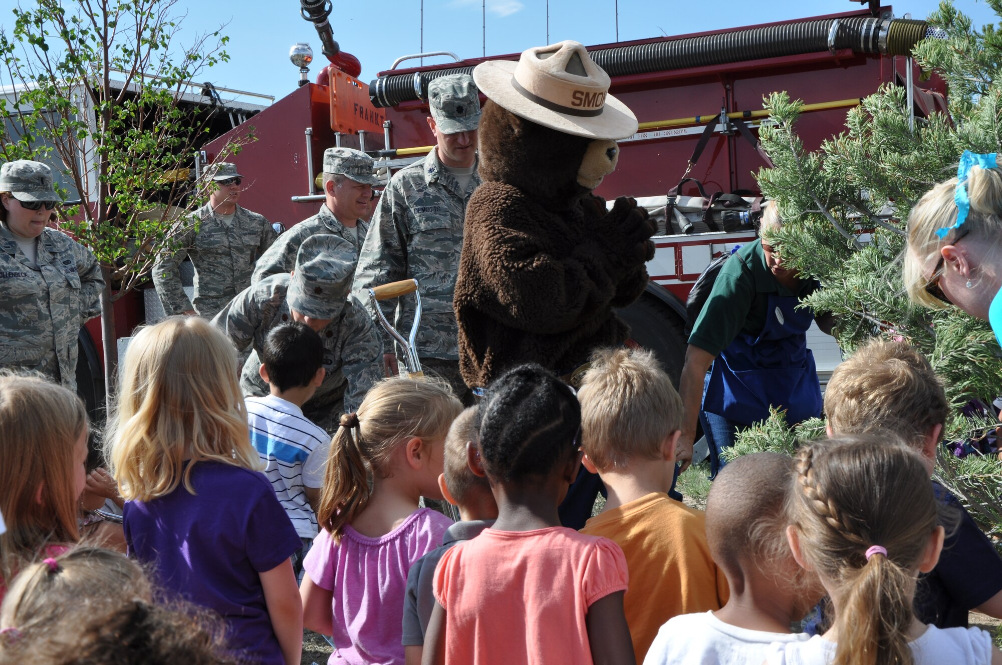 PETERSON AIR FORCE BASE, Colo. – Children from the Peterson East Child Development Center took part in the Arbor Day celebration by helping Smokey the Bear plant a tree July 19. The ceremony marked the 19th consecutive year that Peterson has received the “Tree City USA Award” by the Colorado State Forest Service. (U.S. Air Force photo/Michael Golembesky)