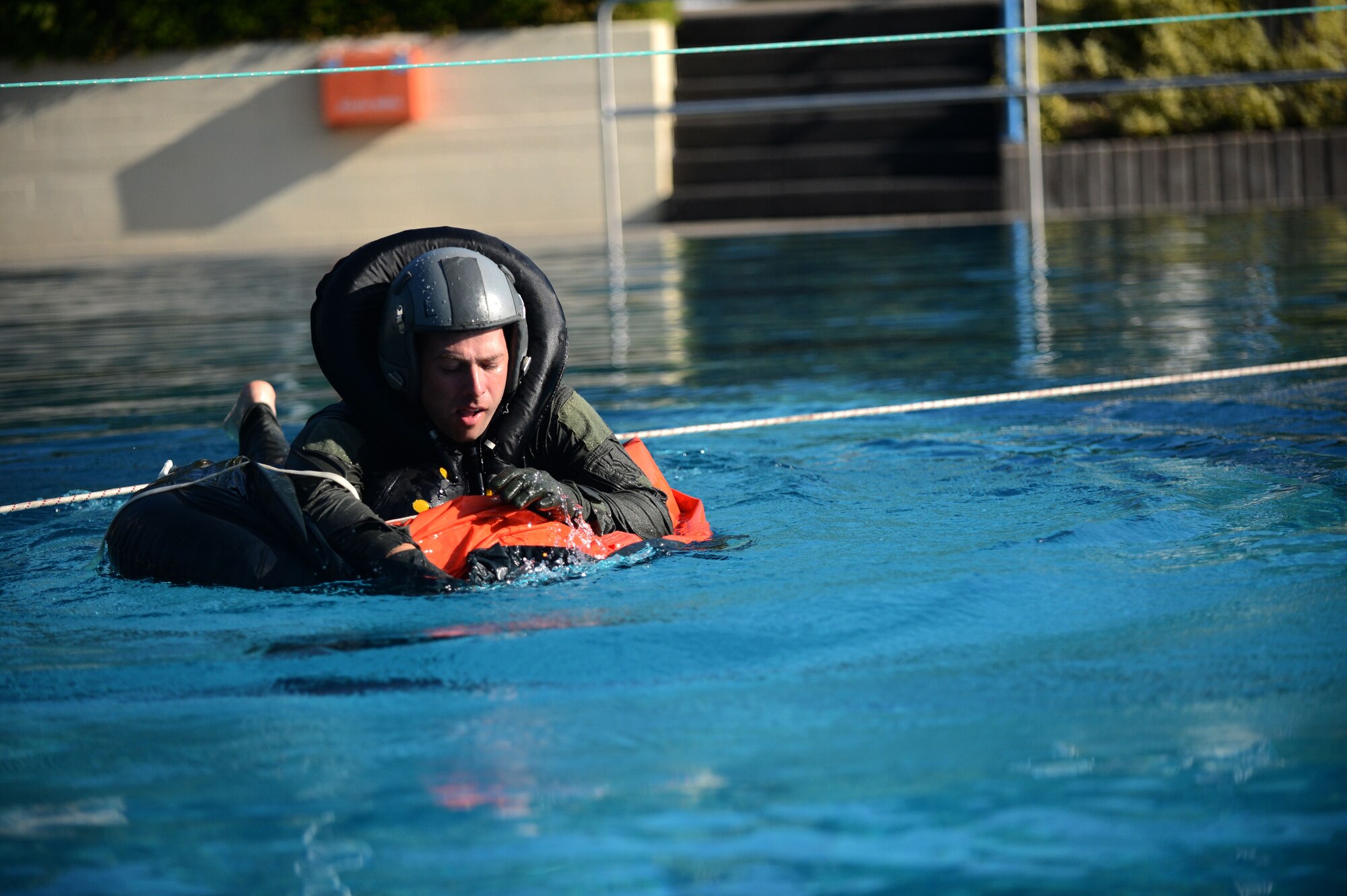 SPANGDAHLEM AIR BASE, Germany – U.S. Air Force Staff Sgt. David Wiggins, 52nd Operations Support Squadron NCO in charge of Survival, Evasion, Resistance and Escape training from Forsyth, Ga., climbs into a life raft during water survival training July 19, 2013. Water survival training is a triennial requirement for pilots and varies depending on which airframe the pilot flies. (U.S. Air Force photo by Airman 1st Class Gustavo Castillo/Released) 