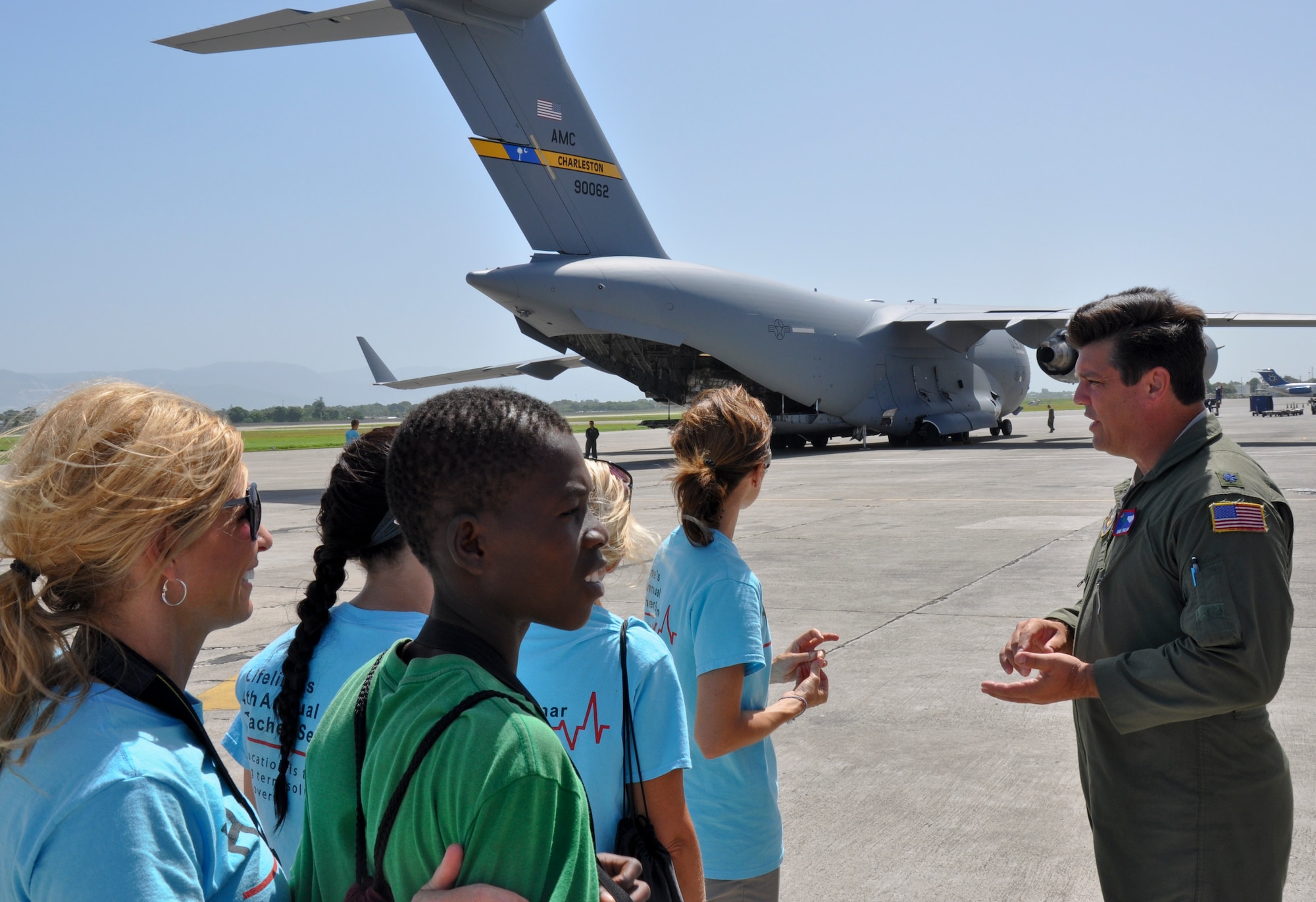 Lt. Col. Mike Phillips talks to aid workers in Haiti as members of the 315th Airlift Wing from Joint Base Charleston, S.C. delivered 86,200 pounds of humanitarian aid to El Salvador and Haiti on a training mission this weekend.  (U.S. Air Force photo by Maj. Wayne Capps)