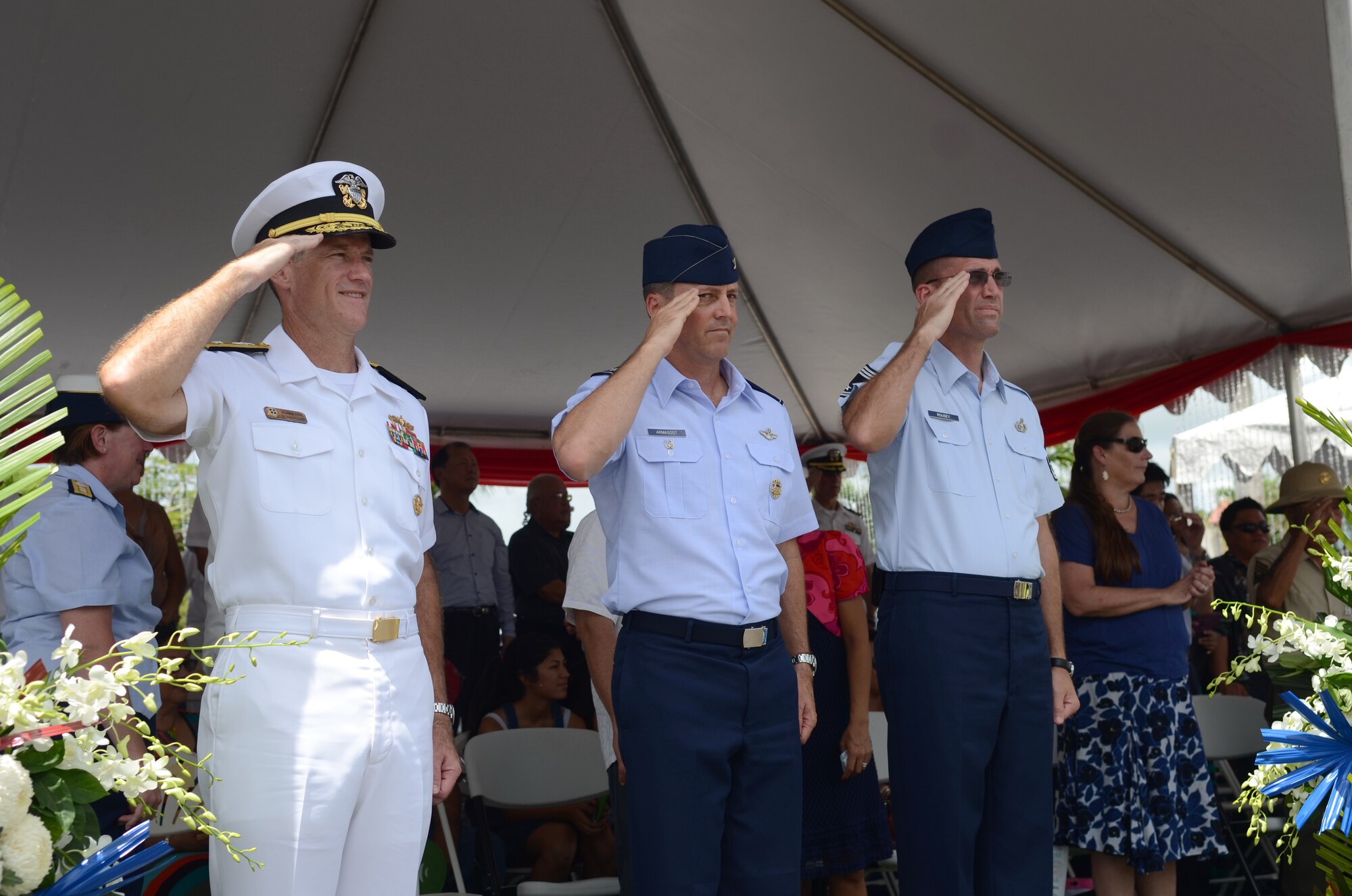 U. S. Navy Rear Adm. Tilghman Payne, Joint Region Marianas commander, Col. Jason Armagost, 36th Wing vice commander, and Chief Master Sgt. Gregory Rousey, 36th Communications Squadron superintendent, return a salute from 36th Wing Airmen as their formation passes during the 69th Liberation Day Parade July 21, 2013, in Hagåtña, Guam. Formations of active-duty service members, guardsmen and reservists, including more than 140 Airmen from the 36th Wing, led the parade down the 1.2-mile route past thousands of spectators. The parade commemorated the United States freeing the island from imperial Japan’s control during the Second Battle of Guam, which began July 21, 1944, and lasted 21 days. (U.S. Air Force photo by Staff Sgt. Brok McCarthy/Released)