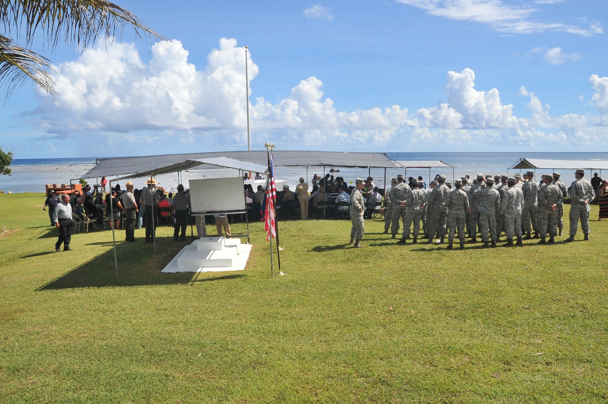 ASAN, Guam -- U.S. Air Force Airmen wait with local citizens for the arrival of Jonas Blas, the mayor of Asan, prior to the start of a ceremony July 18, 2013, paying tribute to the sacrifices made during the 1944 liberation of Guam. The ceremony was one of several held island-wide to commemorate events that occurred during the liberation 69 years ago. (U.S. Air Force photo by Airman 1st Class Adarius Petty/Released)