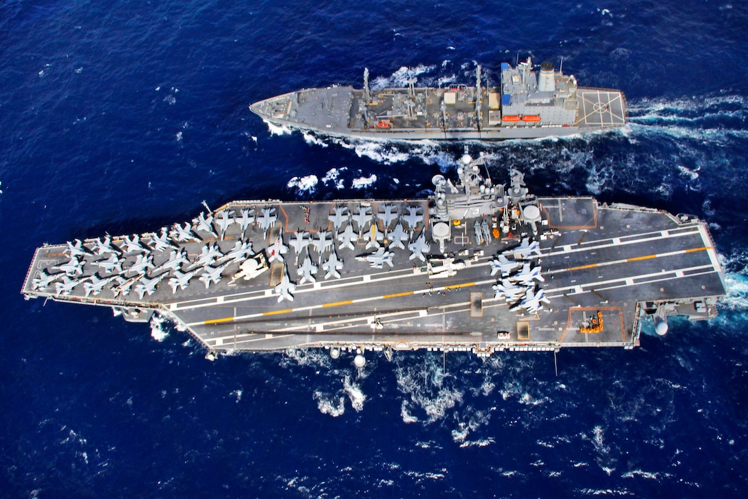 An aerial view of the aircraft carrier USS George Washington shows it conducting a replenishment with the Military Sealift Command fleet replenishment oiler USNS Yukon in the Coral Sea, July 19, 2013. The George Washington and its embarked air wing, Carrier Air Wing 5, are participating in Talisman Saber 2013. The biennial training event is designed to improve Australian and U.S. combat readiness and interoperability as a combined task force.