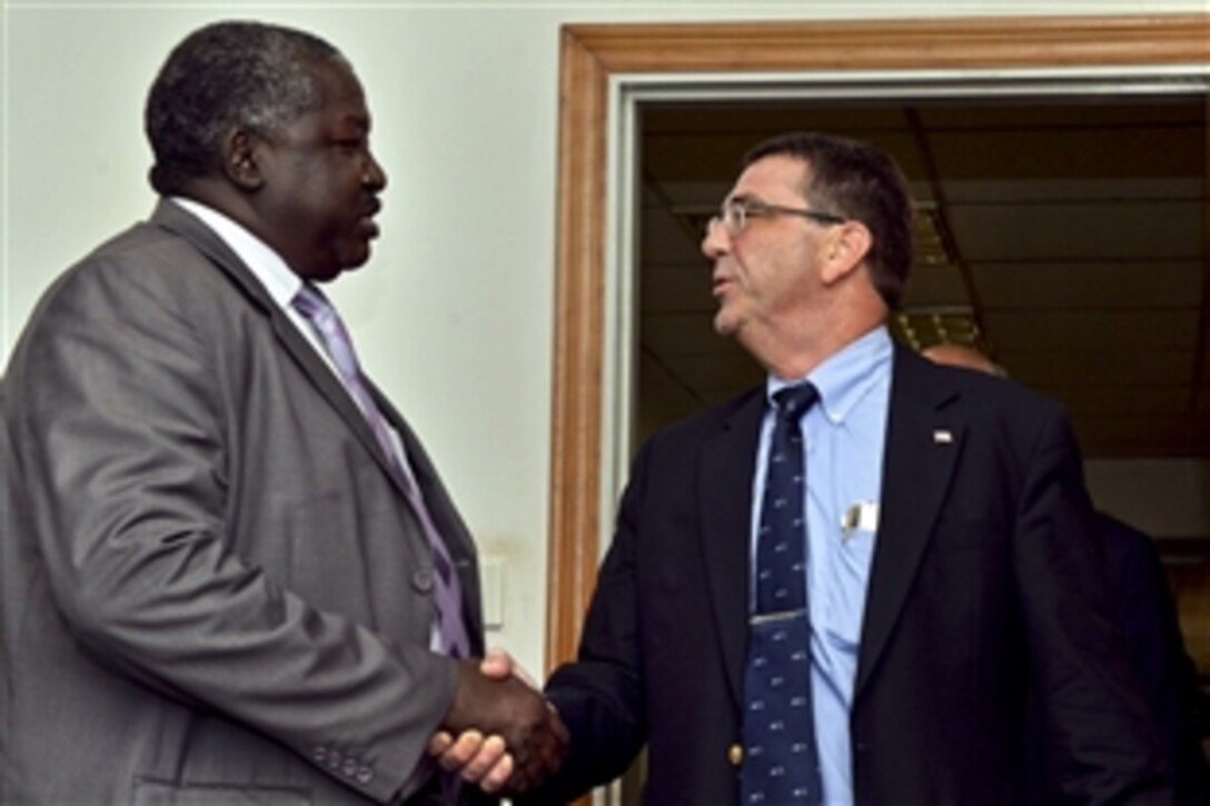 U.S. Deputy Defense Secretary Ash Carter meets with Ugandan Minister of State for Foreign Affairs Okello Oryem at the Ugandan army's general headquarters in Mbuya, Uganda, July 23, 2013. Carter met with government and military leaders to affirm the growing security partnership between the United States and Uganda.