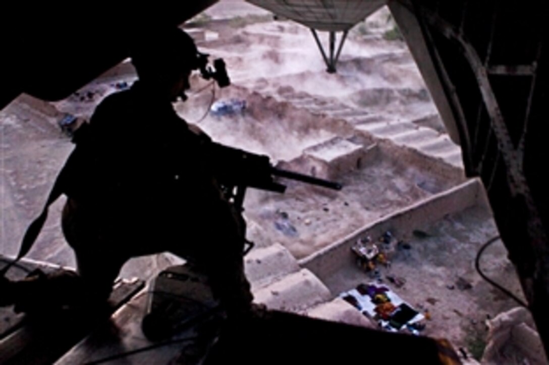 U.S. Marine Sgt. Eric R. Wagner provides aerial security from the back of a CH-53E Super Stallion helicopter during an operation over Helmand province in Afghanistan, July 18, 2013. Wagner, a crew chief, is assigned to Marine Heavy Helicopter Squadron 461.