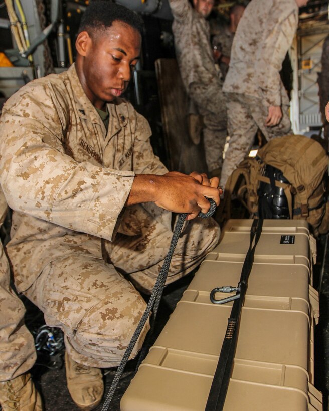 U.S. Marine Cpl. Isaiah Henderson, native of Oakland, Calif., and field artillery cannoneer assigned to Battalion Landing Team 3/2, 26th Marine Expeditionary Unit (MEU), ties a knot while securing a pelican case to be belayed while conducting high rope suspension training in a static MV-22B Osprey on USS Kearsarge (LHD 3), at sea, July 23, 2013. The 26th MEU is a Marine Air-Ground Task Force forward-deployed to the U.S. 5th Fleet area of responsibility aboard the Kearsarge Amphibious Ready Group serving as a sea-based, expeditionary crisis response force capable of conducting amphibious operations across the full range of military operations. (U.S. Marine Corps photo by Sgt. Christopher Q. Stone, 26th MEU Combat Camera/Released)