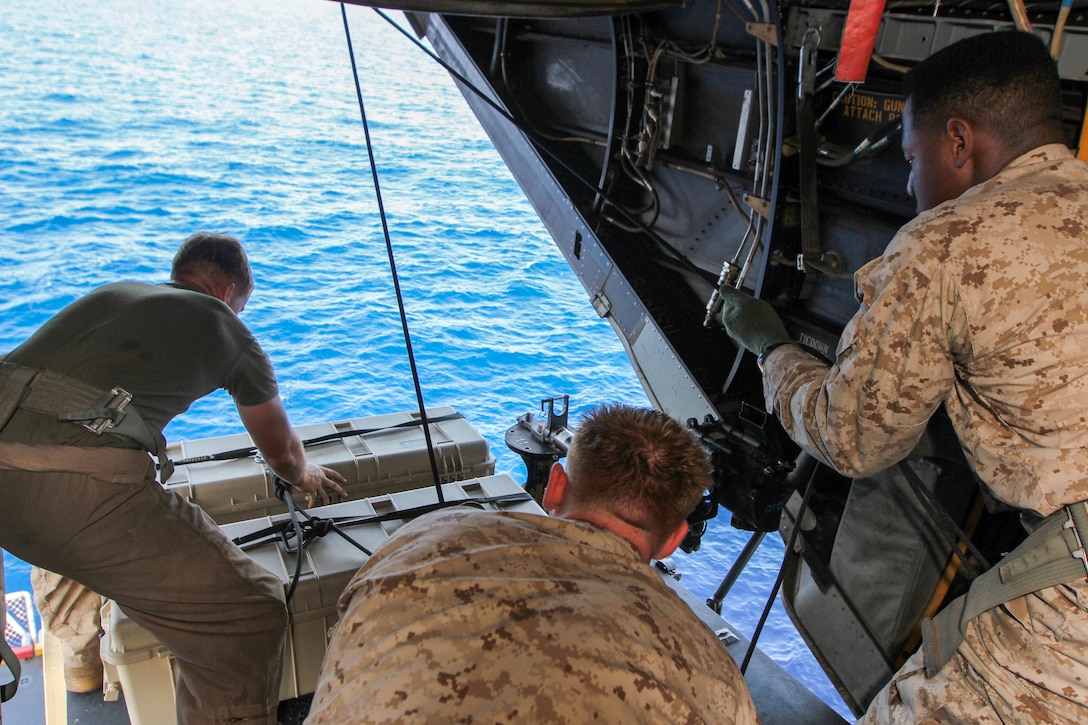 U.S. Marines assigned to Battalion Landing Team 3/2 and Marine Medium Tiltrotor Squadron (VMM) 266 (Reinforced), 26th Marine Expeditionary Unit (MEU), lower pelican cases and main packs while conducting high rope suspension training in a static MV-22B Osprey on USS Kearsarge (LHD 3), at sea, July 23, 2013. The 26th MEU is a Marine Air-Ground Task Force forward-deployed to the U.S. 5th Fleet area of responsibility aboard the Kearsarge Amphibious Ready Group serving as a sea-based, expeditionary crisis response force capable of conducting amphibious operations across the full range of military operations. (U.S. Marine Corps photo by Sgt. Christopher Q. Stone, 26th MEU Combat Camera/Released)