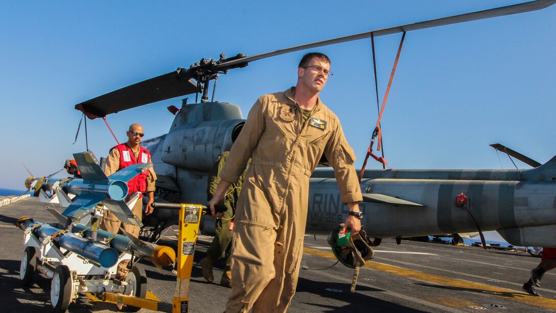 U.S. Marine Corps ordinance technicians transport AIM-9 training rockets to an AH-1W Super Cobra assigned to Marine Medium Tiltrotor Squadron (VMM) 266 (Reinforced), 26th Marine Expeditionary Unit (MEU), on the flight deck of the USS Kearsarge (LHD 3), at sea, July 23, 2013. The 26th MEU is a Marine Air-Ground Task Force forward-deployed to the U.S. 5th Fleet area of responsibility aboard the Kearsarge Amphibious Ready Group serving as a sea-based, expeditionary crisis response force capable of conducting amphibious operations across the full range of military operations. (U.S. Marine Corps photo by Sgt. Christopher Q. Stone, 26th MEU Combat Camera/Released)