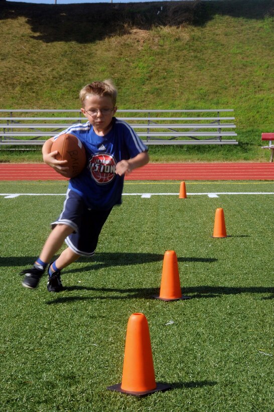 Jack, 6, runs a drill during a flag football camp aboard Marine Corps Base Quantico on July 23, 2013. The camp is the first football camp hosted aboard base.