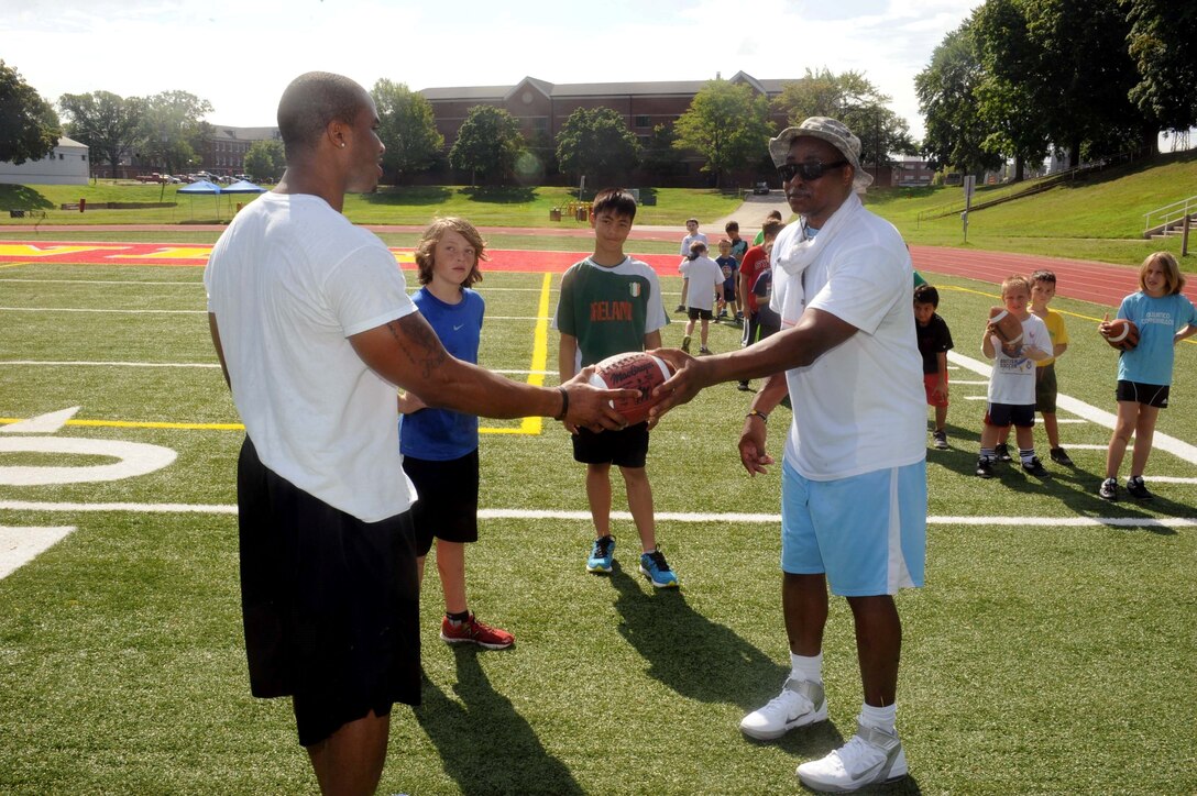 Coaches Troy Cheatham and Darnell West teach a flag football class aboard Marine Corps Base Quantico on July 23, 2013. The camp, designed for five to 12 year olds, is the first football camp hosted on the base.