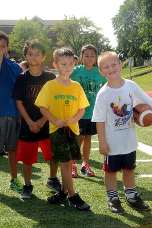 Children ages five to 12 wait for a drill to start during a flag football camp aboard Marine Corps Base Quantico on July 23, 2013. Over a dozen children registered for the first football camp hosted aboard base.