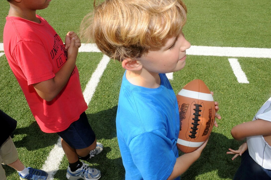Christopher, 6, listens to directions from his coach during a flag football camp aboard Marine Corps Base Quantico on July 23, 2013. The camp, designed for five to 12 year olds, is the first football camp hosted on the base.