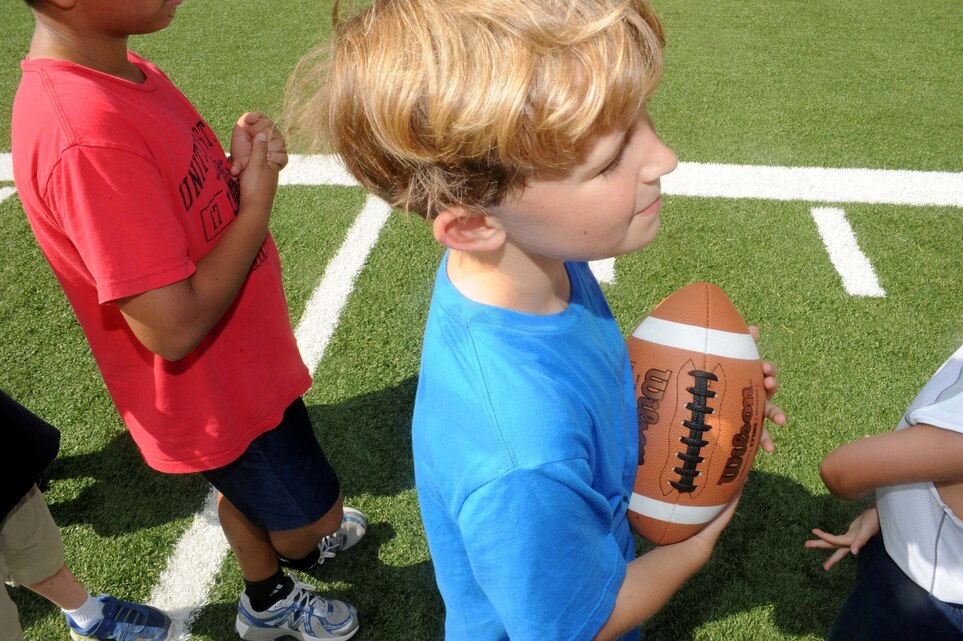 Christopher, 6, listens to directions from his coach during a flag football camp aboard Marine Corps Base Quantico on July 23, 2013. The camp, designed for five to 12 year olds, is the first football camp hosted on the base.