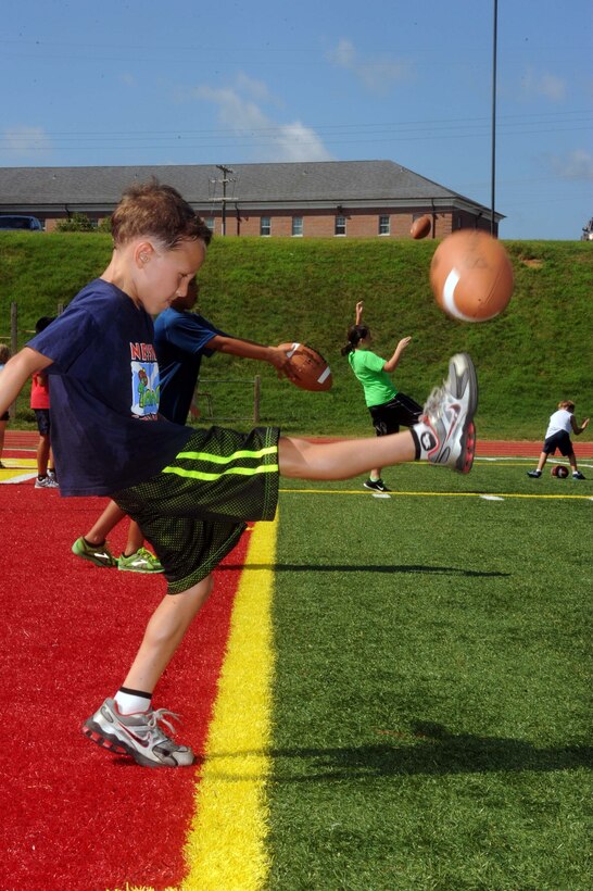 Will, 6, kicks a football during a flag football camp at Marine Corps Base Quantico on July 23, 2013. The camp is the first football camp hosted aboard base.