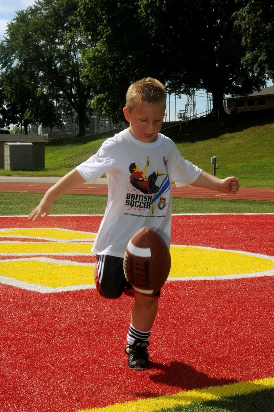 Thomas, 5, kicks a football during a flag football camp aboard Marine Corps Base Quantico on July 23, 2013. The camp is the first football camp hosted aboard base.