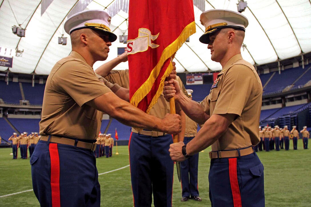 Maj. Christopher Tsirlis accepts Recruiting Station Twin Cities' organizational colors from Maj. Kenneth Gawronski during a change of command ceremony June 28 at Mall of America Field inside the Metrodome. For additional imagery from the event, visit www.facebook.com/rstwincities.  