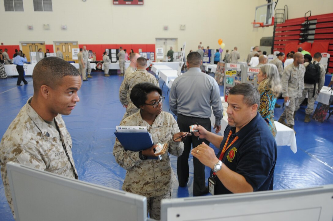 Nelson Ocasio talks with Sgt. Timmion Banton and Pfc. Ashley Antoine, both new to The Basic School, at Marine Corps Base Quantico's Welcome Aboard brief July 17. Organizers have traded the old PowerPoint-centered brief for a more interactive model. 