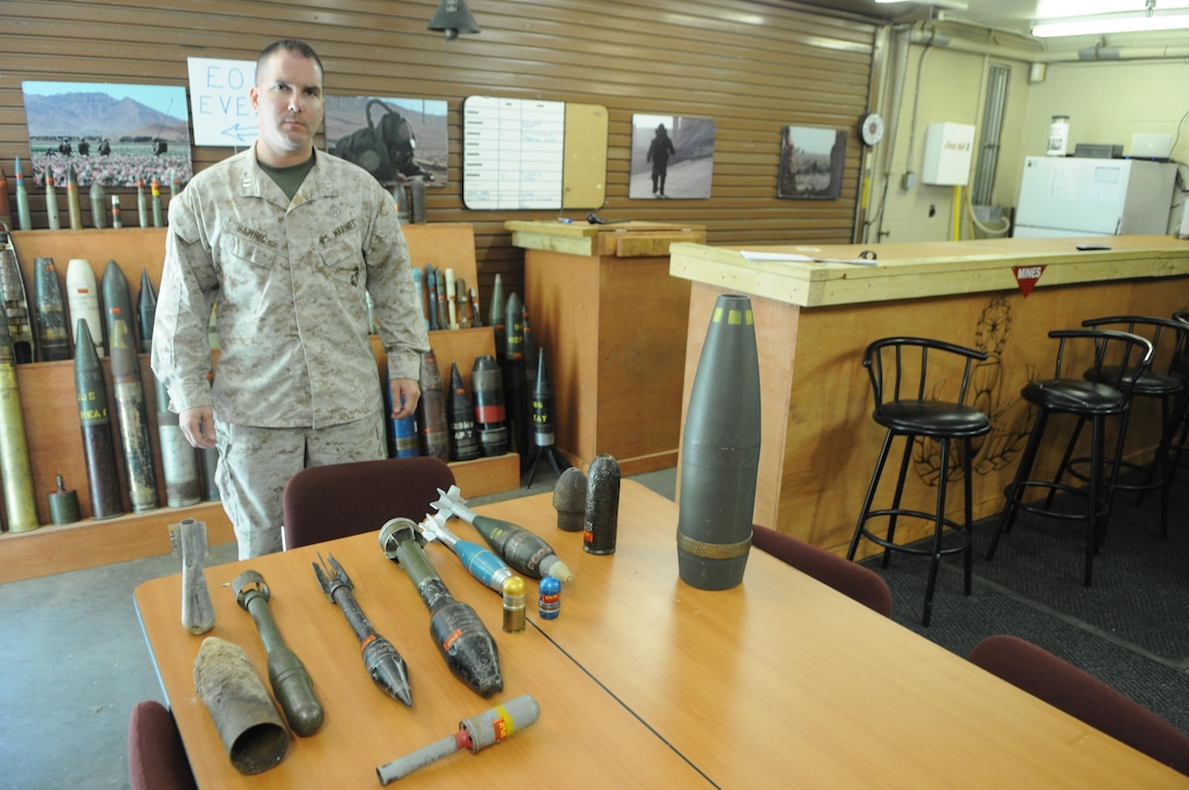 Capt. Jeremiah Hamric, officer in charge, Explosive Ordnance Disposal, shows some of the rounds most commonly found unexploded around Marine Corps Base Quantico. 
