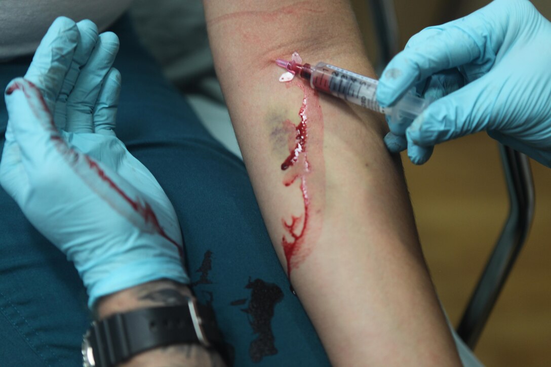 Gunnery Sgt. Russell Whaley, a Reintegrate, Educate and Advance Combatants in Healthcare program participant successfully provides Intravenous (IV) to a hospital corpsman after stopping blood from escaping the injection. Career planners look toward enrolling wounded warriors and prior service Marines and Sailors to the program. 