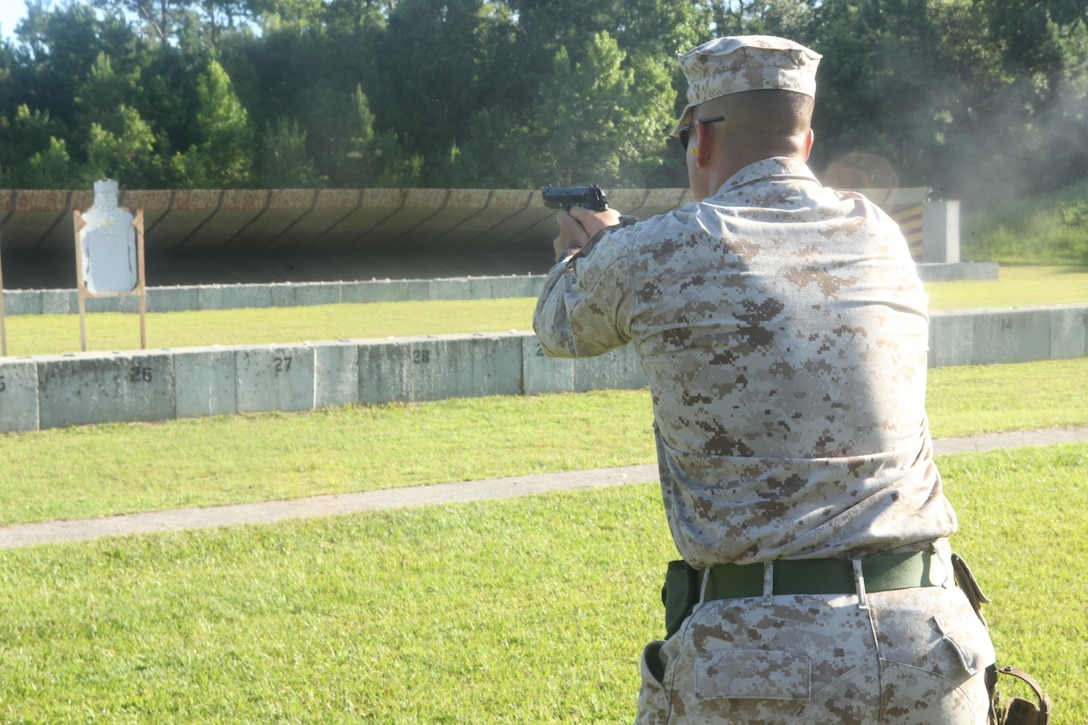 Capt. Steven L. Kosnik, operations officer, Weapons Training Battalion at Stone Bay Rifle Range, a satellite installation of Marine Corps Base Camp Lejeune engages the enemy target during the Combat Pistol Program, July 11. The program is replacing the current pistol marksmanship course. 