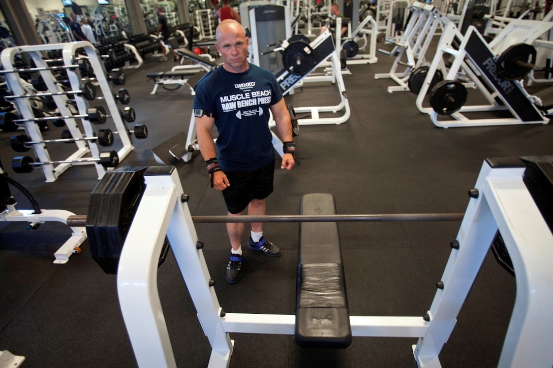 Staff Sgt. Matthew Reep, the assault chief for Division Schools, 1st Marine Division, prepares for his chest workout at the Camp Margarita gym here, July 17, 2013. Standing at 5 feet 2 inches, the 165-pound native of Lexington, S.C., currently holds three world records in powerlifting, which he established during a tournament in Las Vegas.