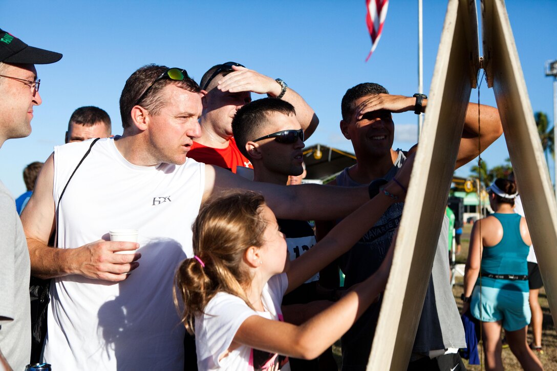 Competitors gather post-race to see their scores for the Camp Smith 5K Grueler here July 20. While many service members participated with their families, the race attracted many mainland visitors who ran to fulfill an added goal during their vacation. 